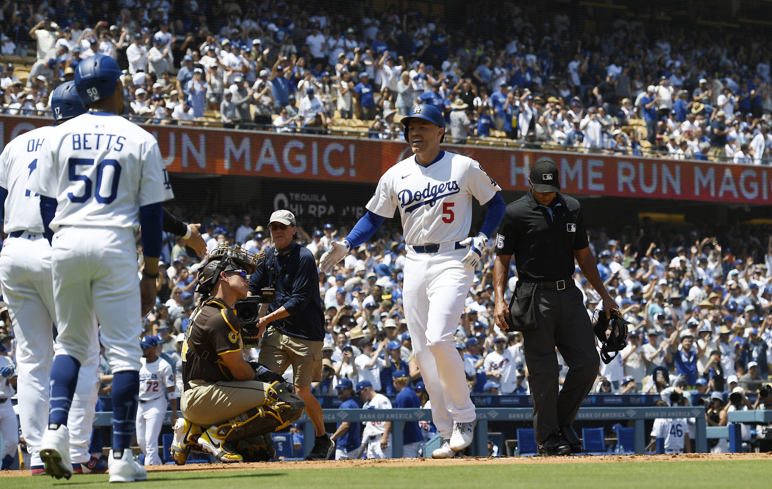 The Dodgers’ Freddie Freeman (5) is congratulated by Mookie Betts...