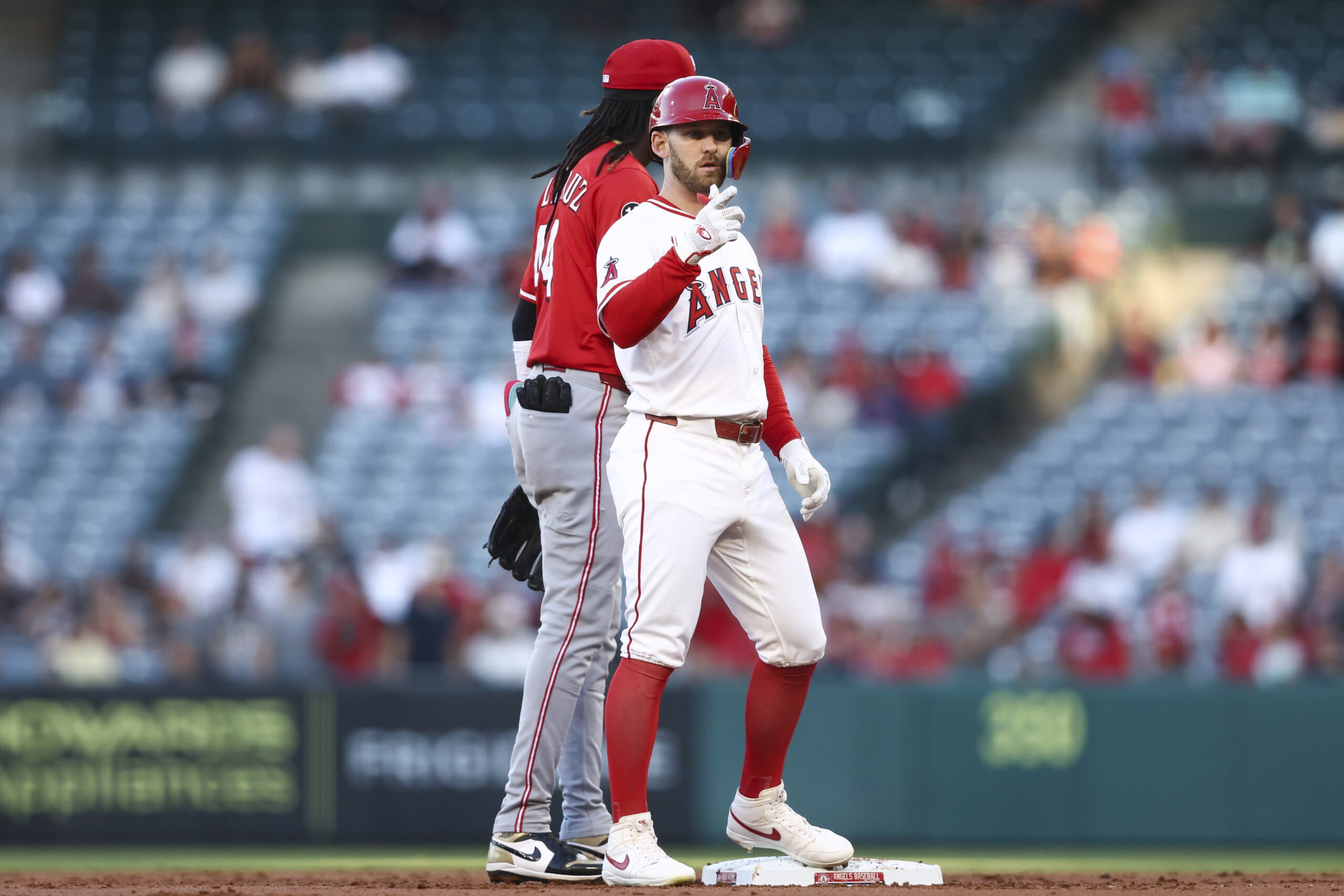 The Angels’ Taylor Ward, right, gestures after hitting an RBI...