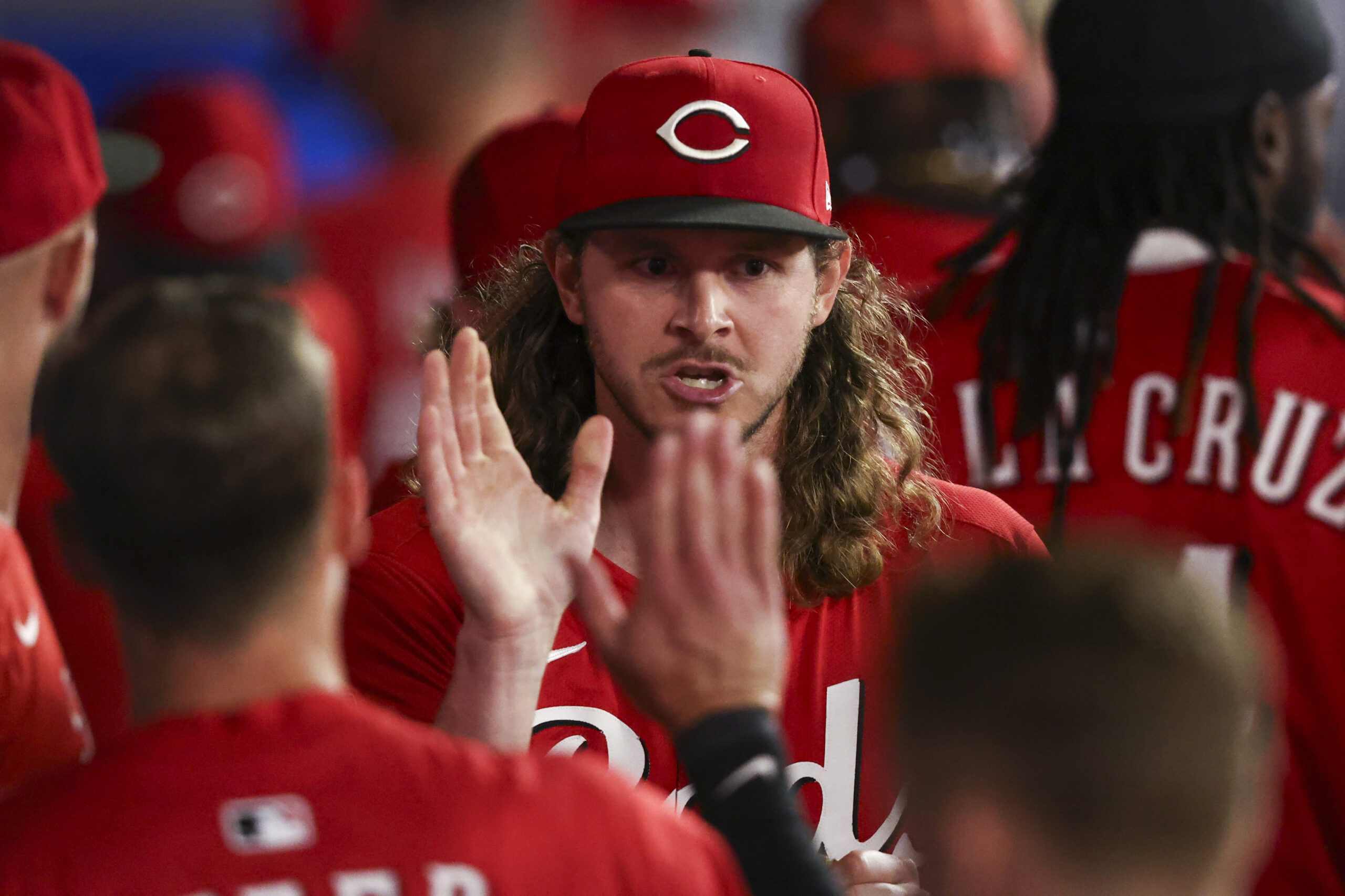 Cincinnati Reds pitcher Scott Barlow celebrates in the dugout with...