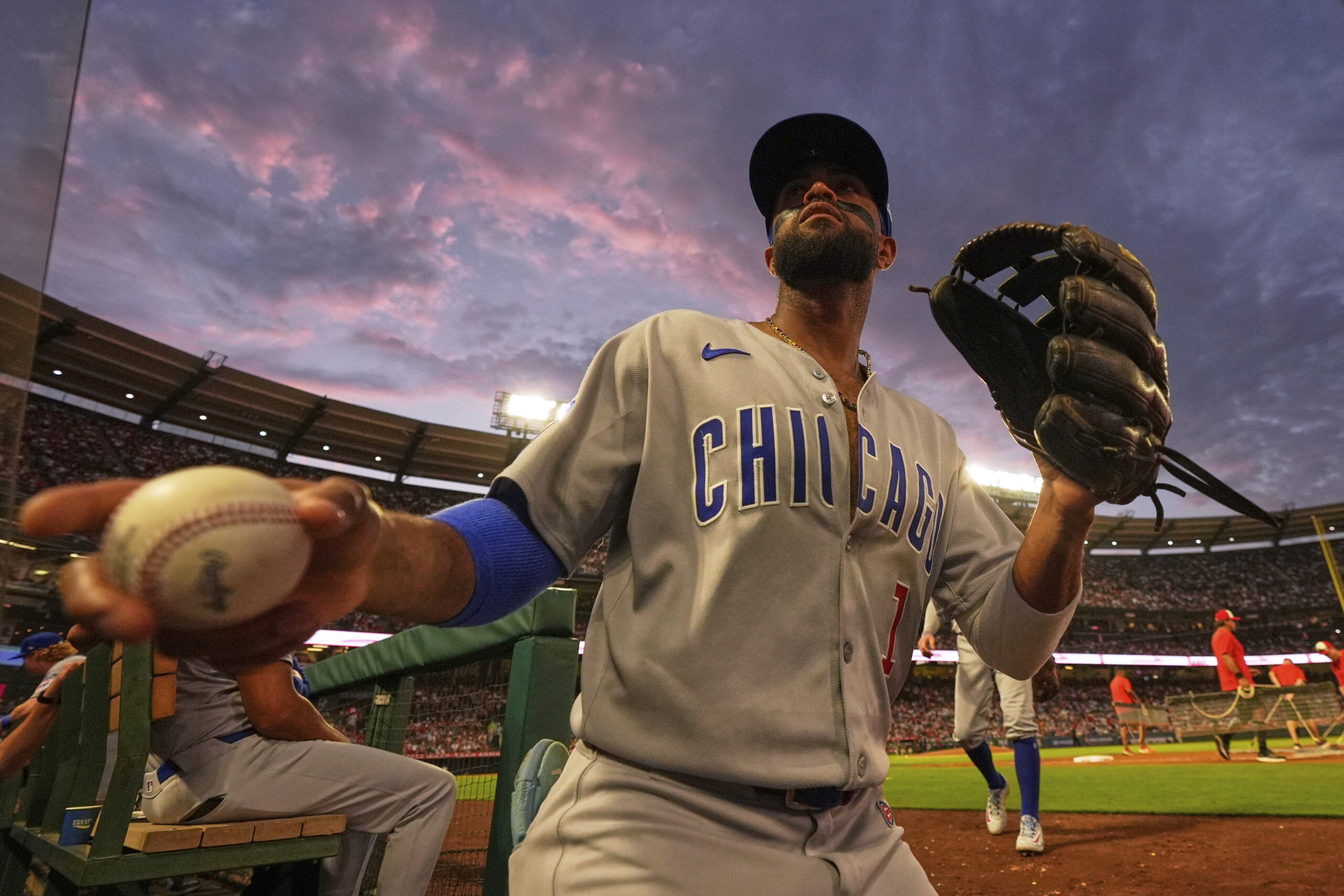 Chicago Cubs’ Willi Castro tosses a ball to a fan...