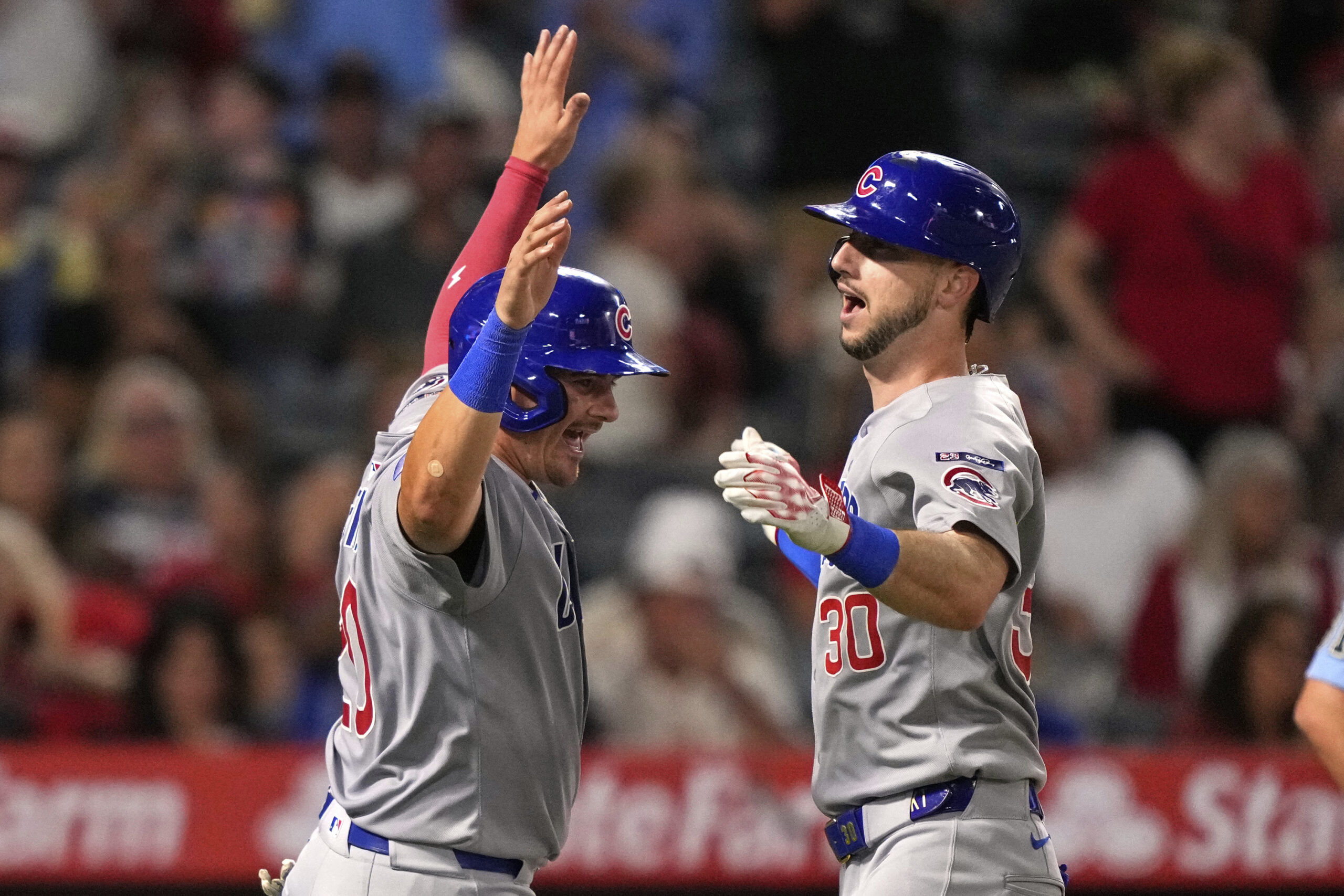 Chicago Cubs’ Kyle Tucker, right, is congratulated by Reese McGuire...