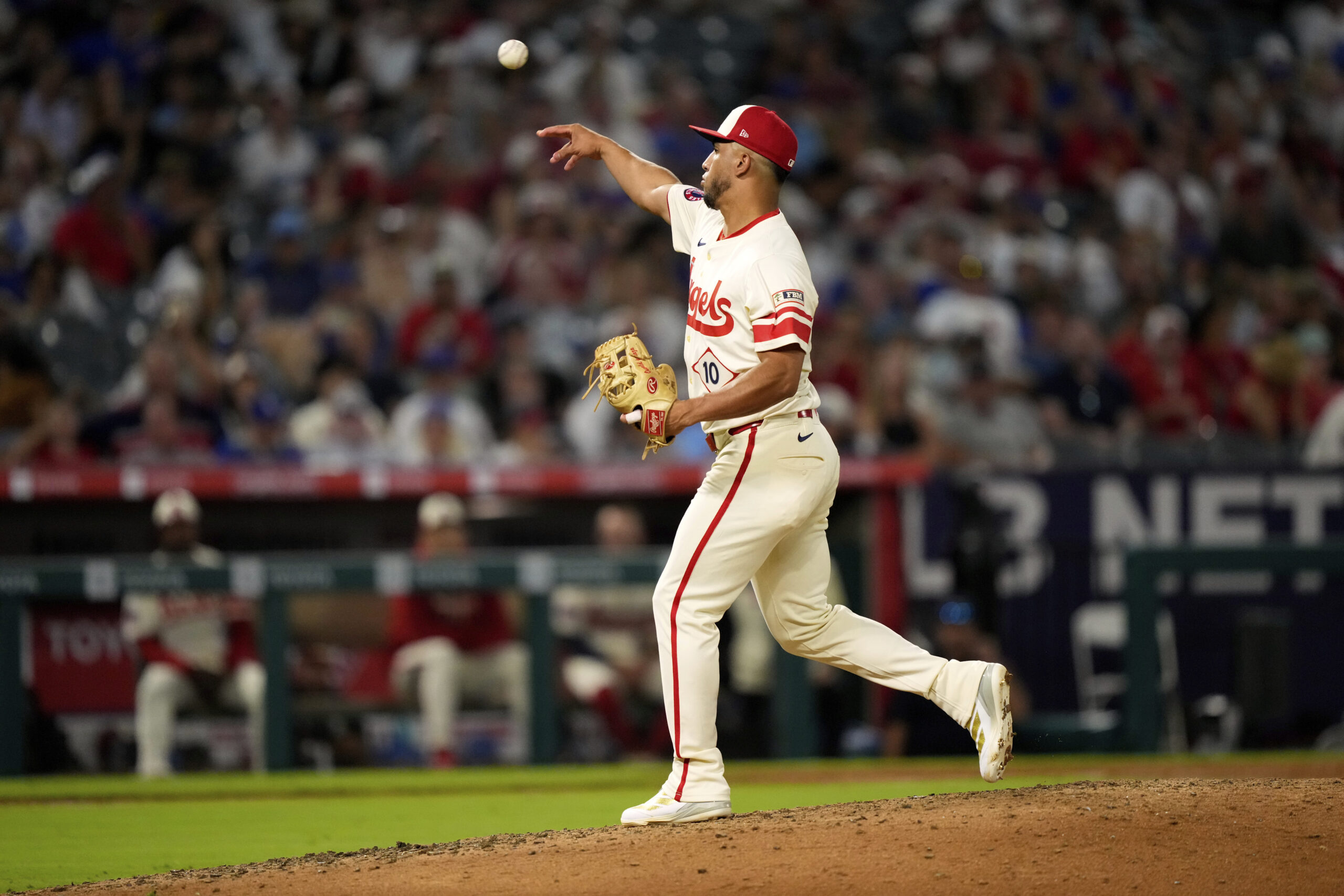 Angels position player Oswald Peraza throws to the plate during...