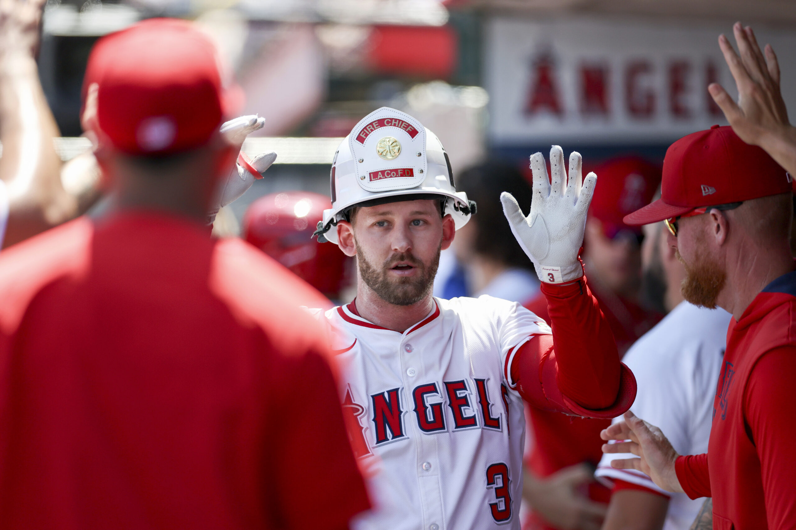 The Angels’ Taylor Ward celebrates with teammates in the dugout...