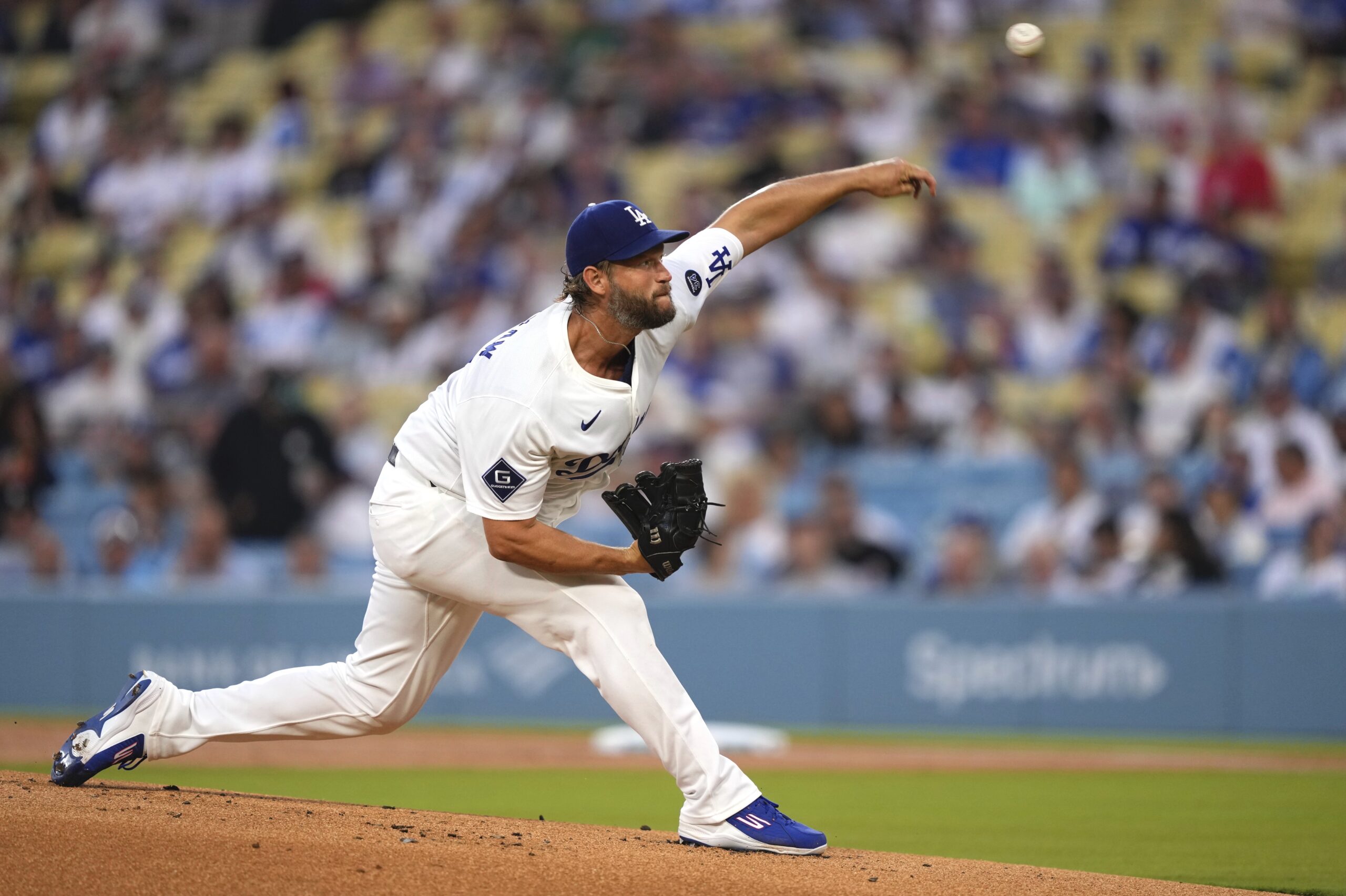 Dodgers starting pitcher Clayton Kershaw throws to the plate during...