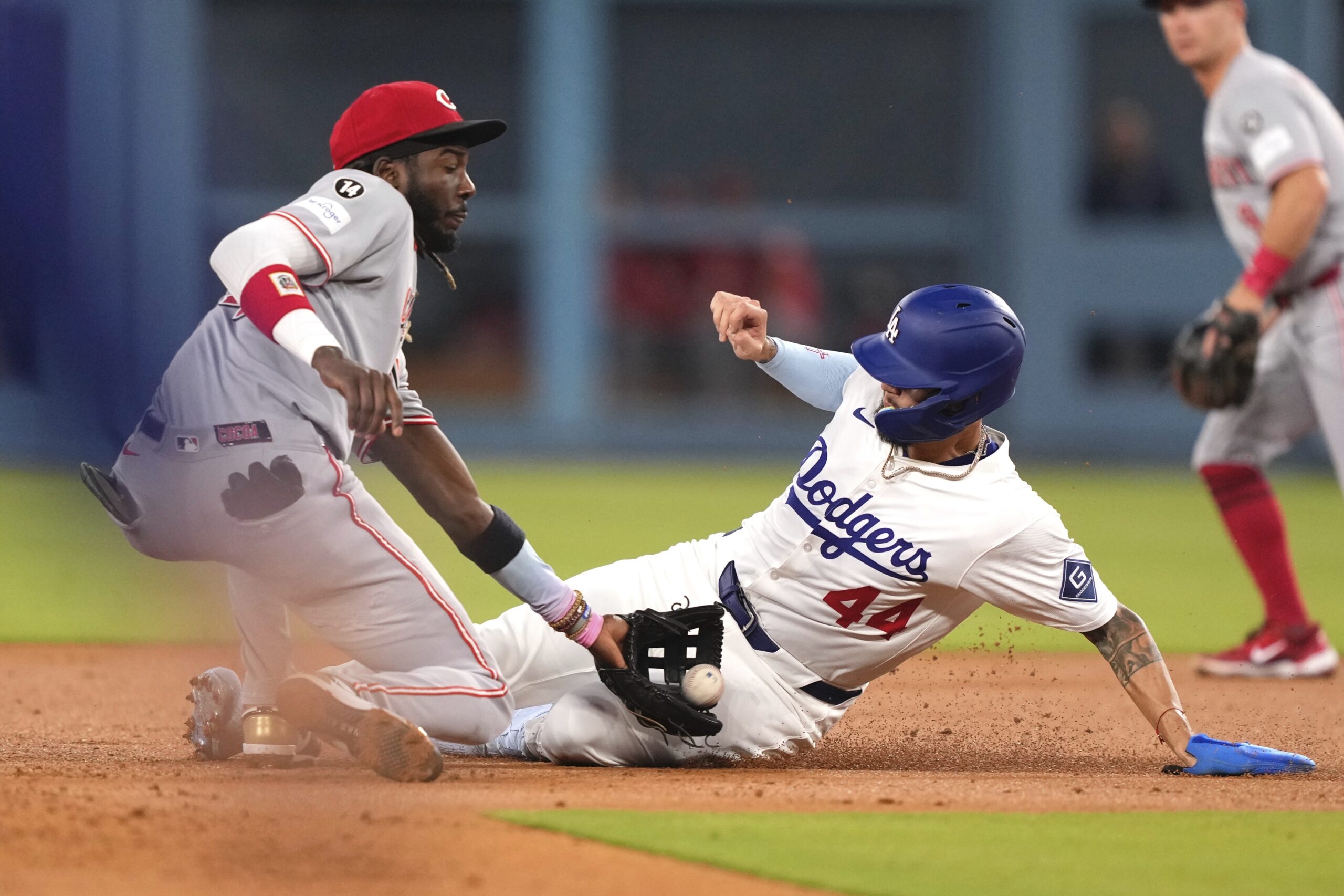 The Dodgers’ Andy Pages, right, is tagged out by Cincinnati...