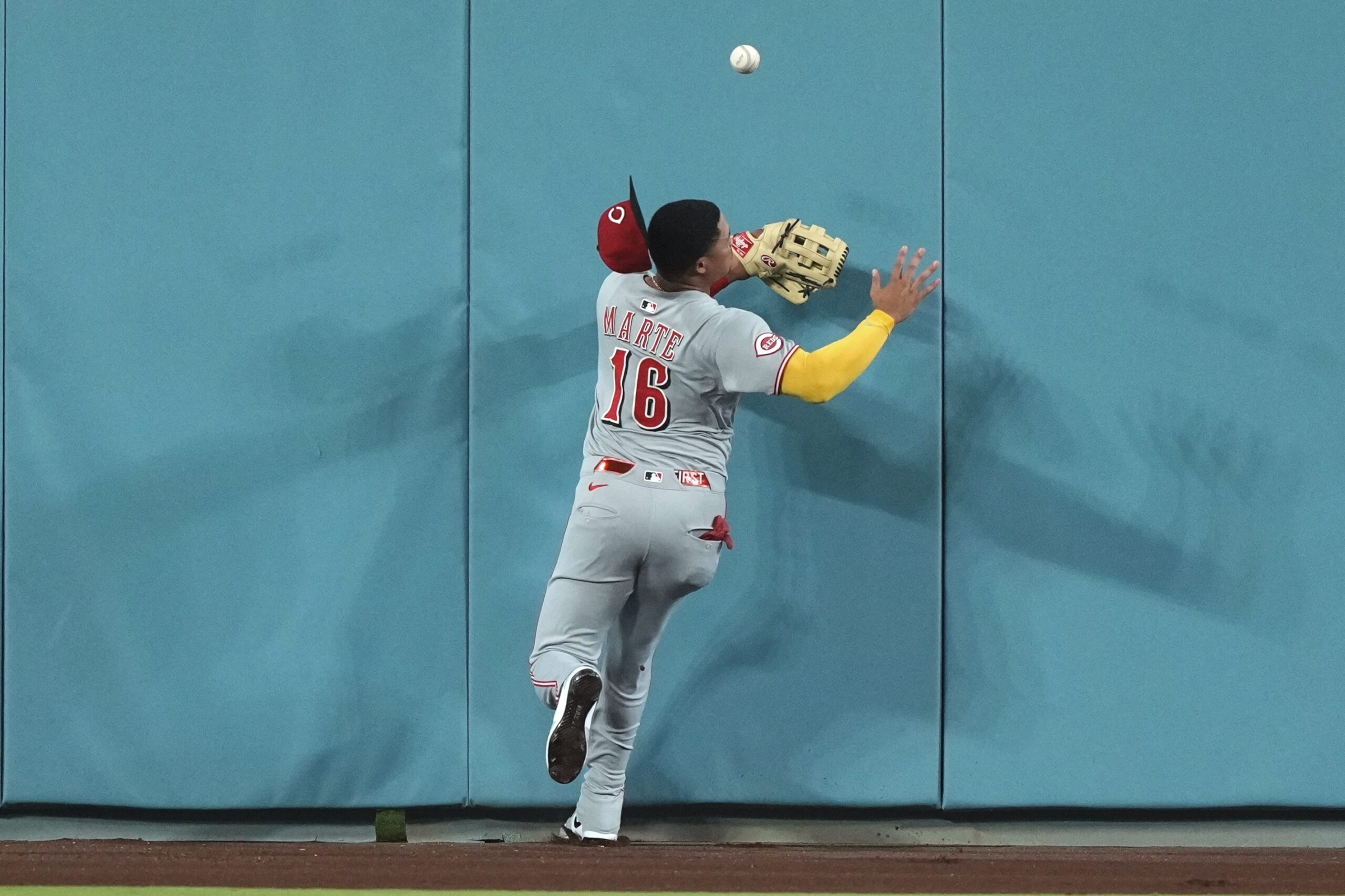 Cincinnati Reds center fielder Noelvi Marte collides with the wall...