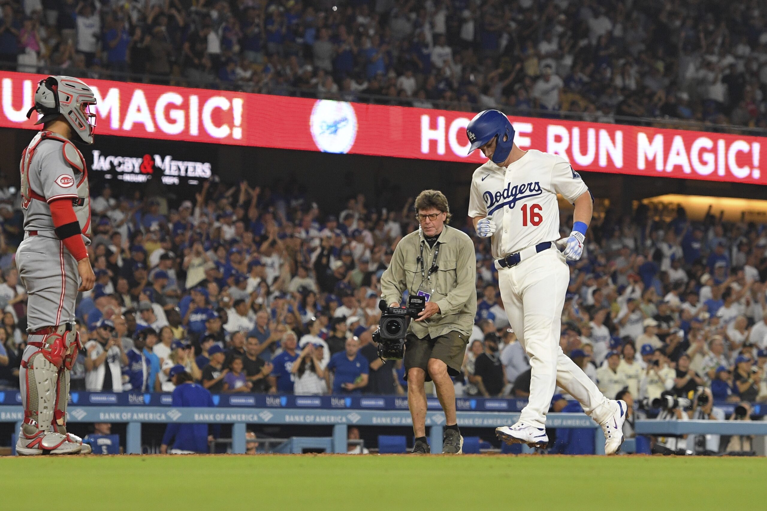 The Dodgers’ Will Smith, right, scores after hitting a solo...