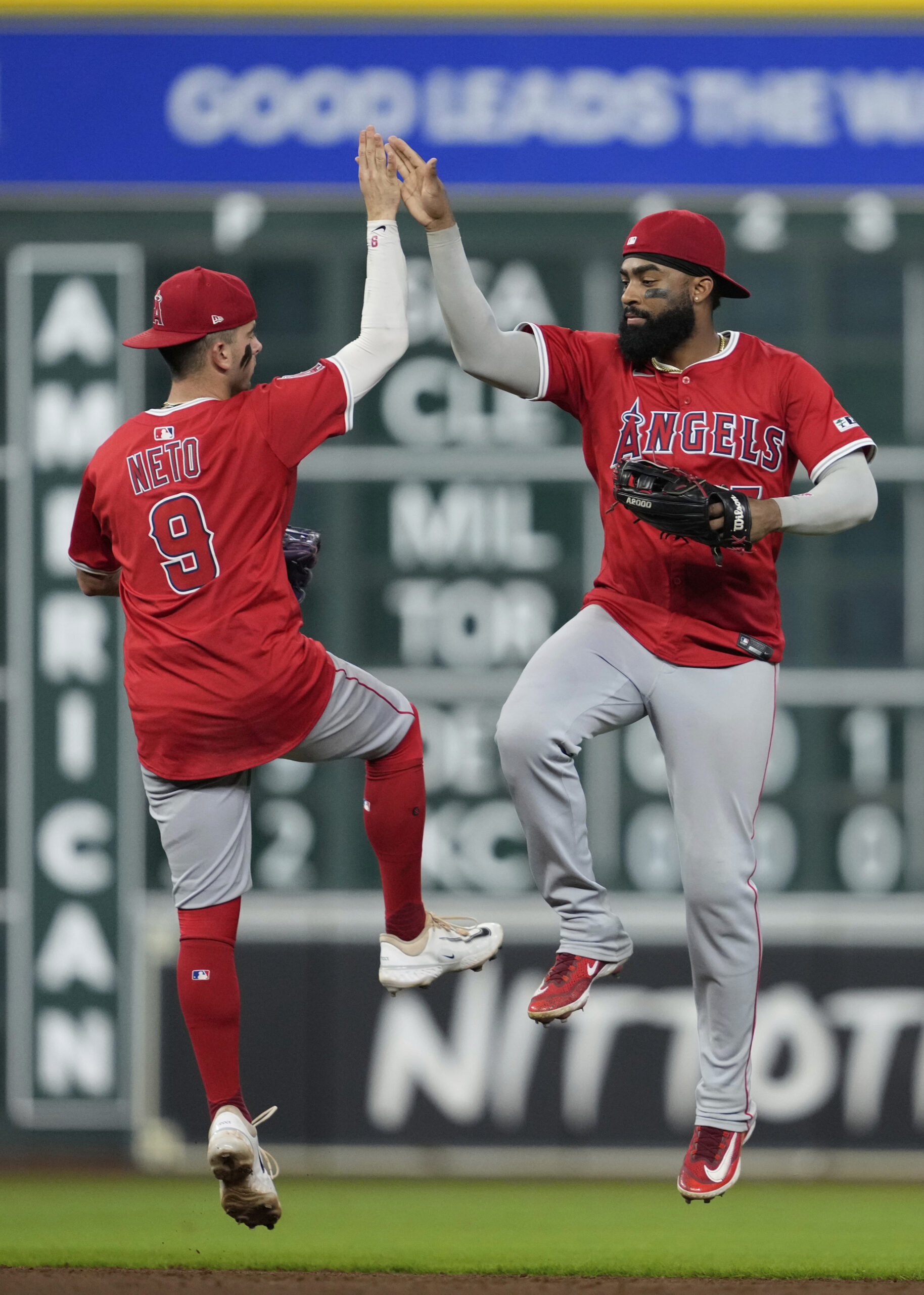 Angels shortstop Zach Neto (9) and right fielder Jo Adell...
