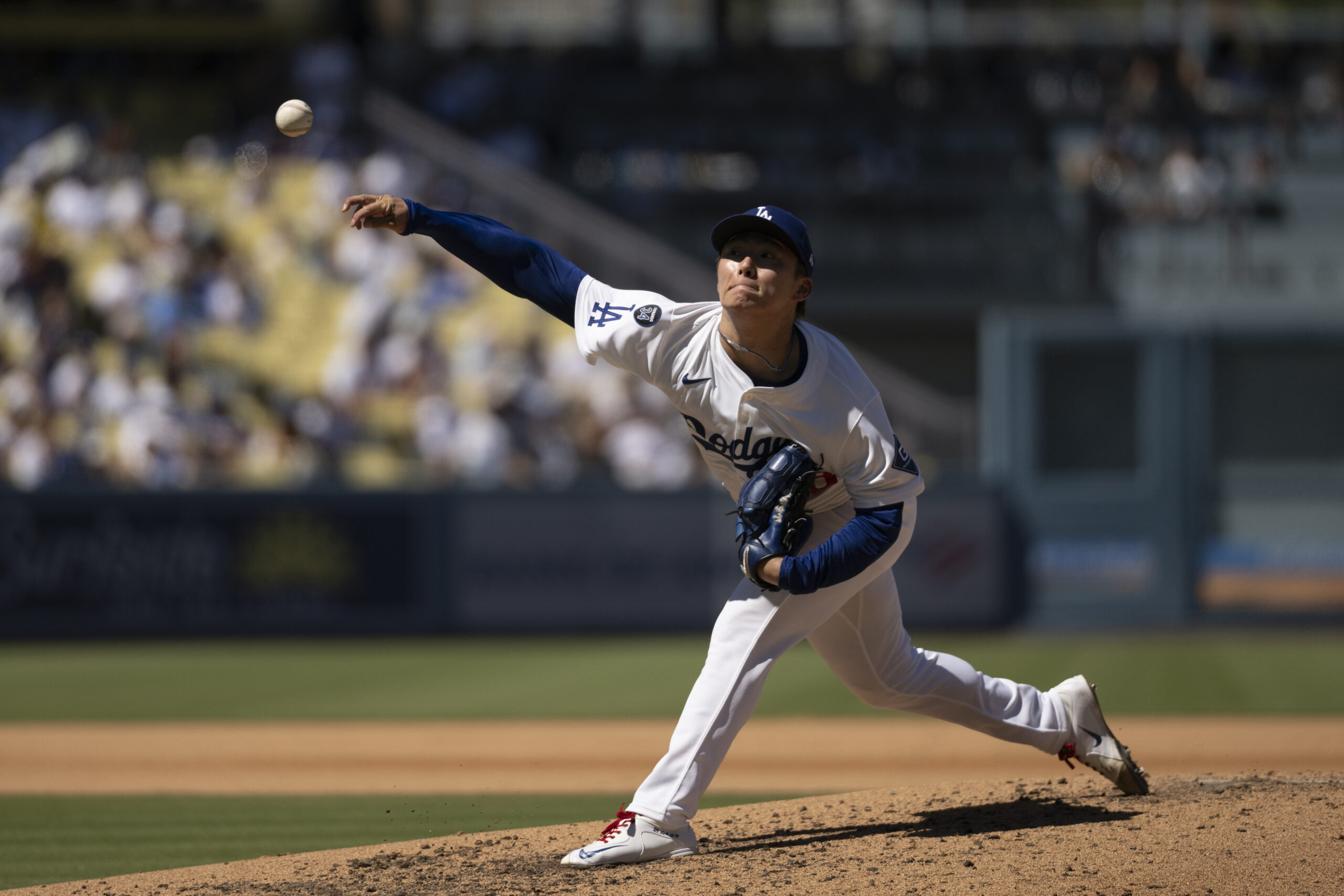 Dodgers starting pitcher Yoshinobu Yamamoto delivers during the sixth inning...