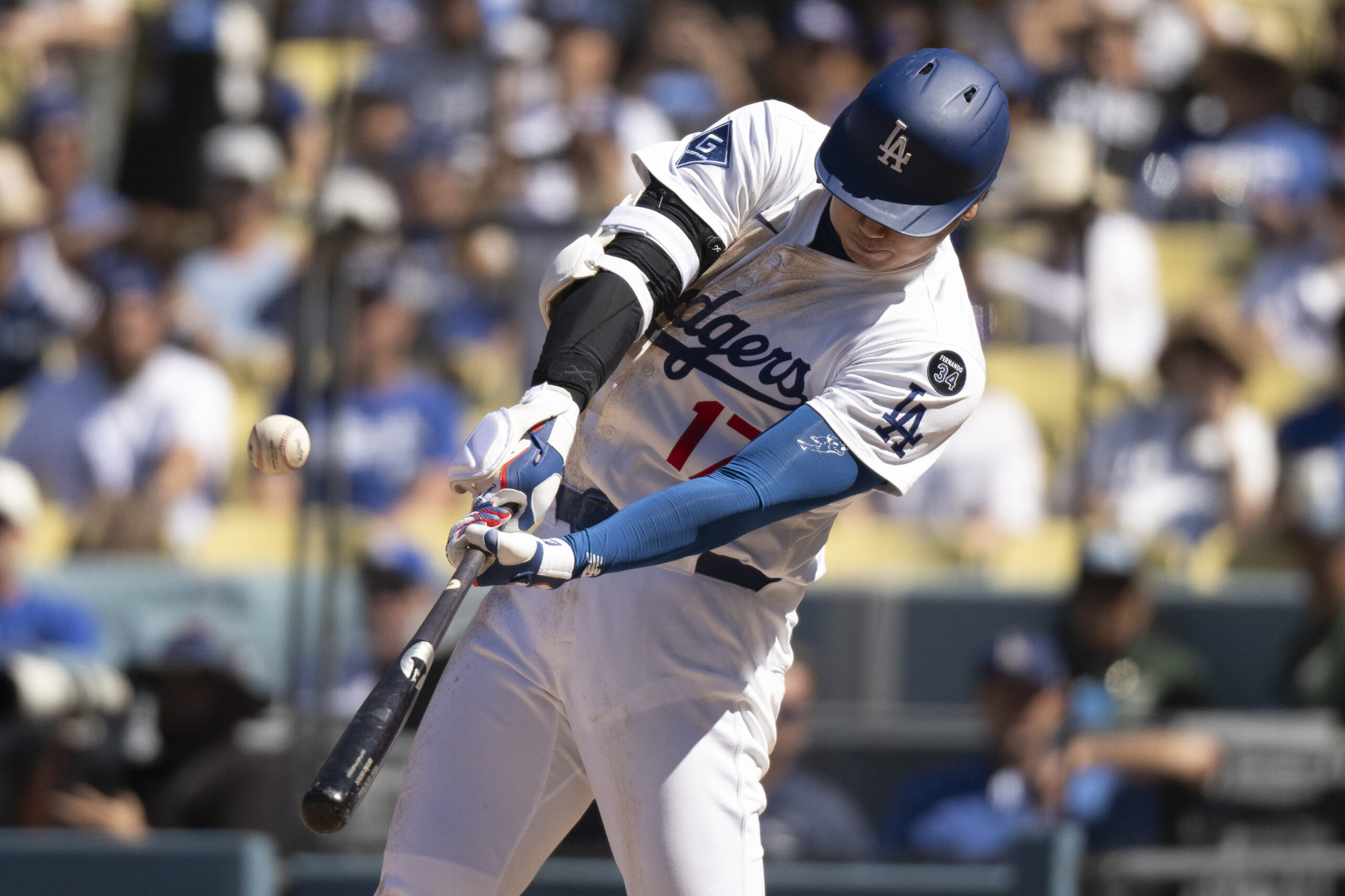 Dodgers’ Shohei Ohtani hits a fly ball during the seventh...