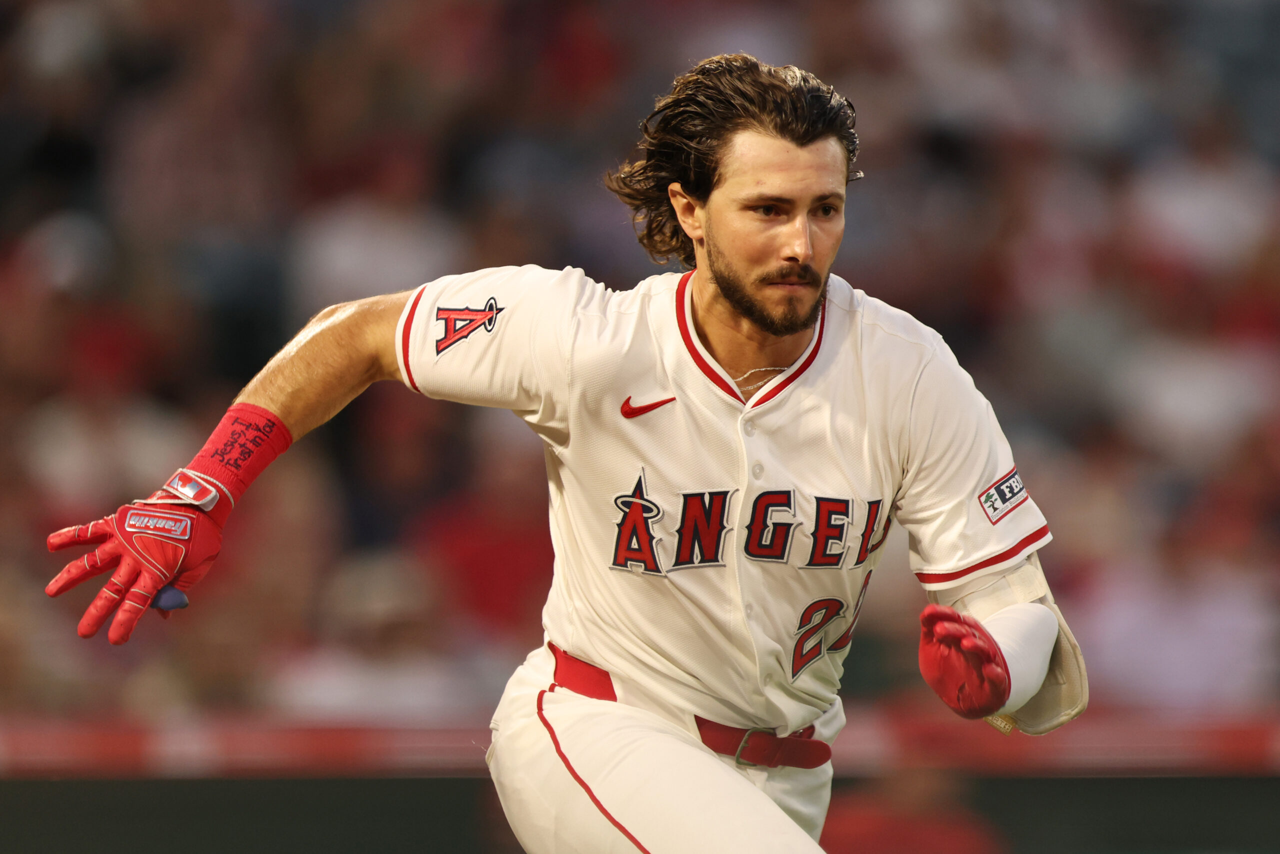 The Angels’ Bryce Teodosio runs to first base during the...