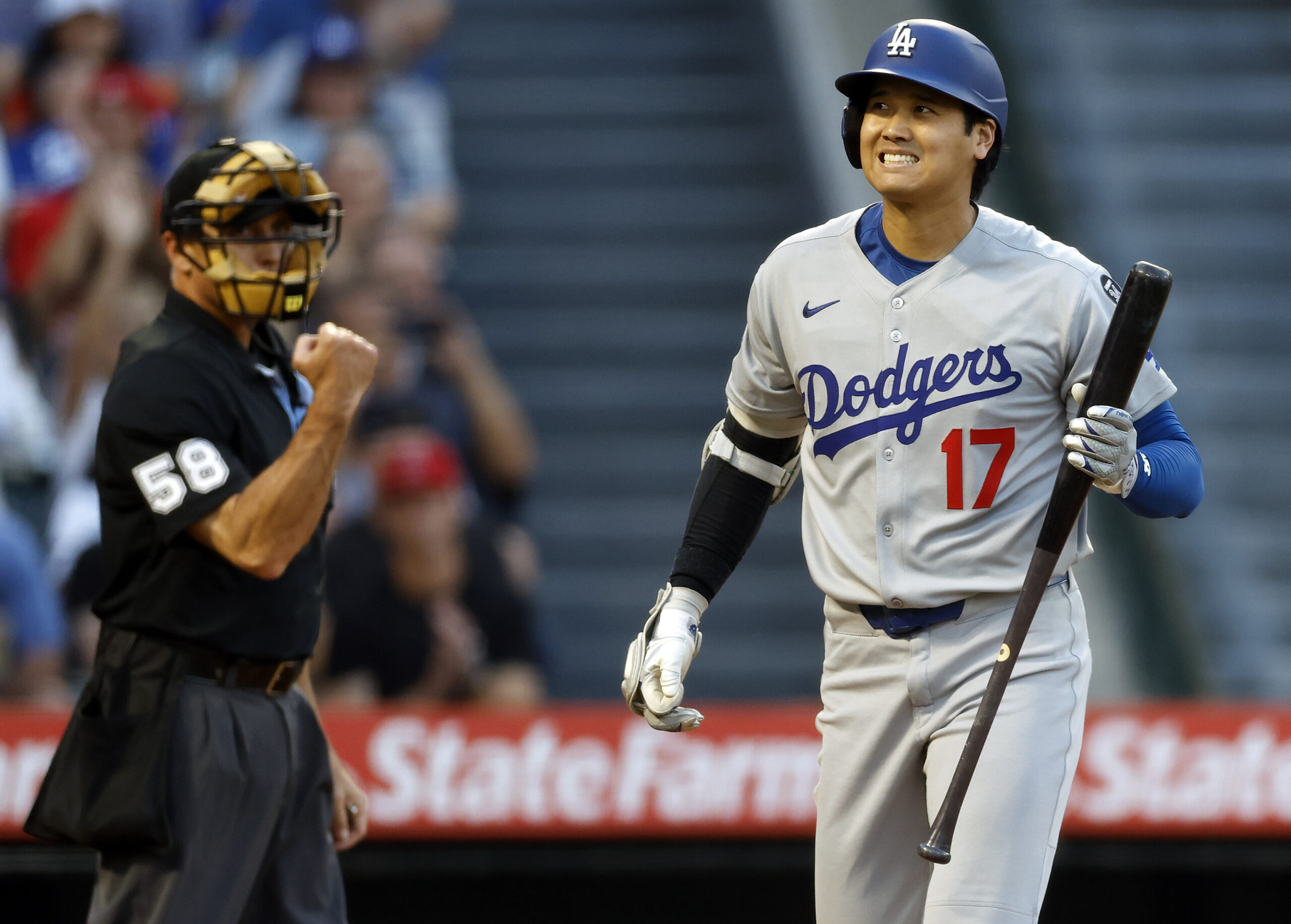 Dodgers star Shohei Ohtani reacts after striking out during the...