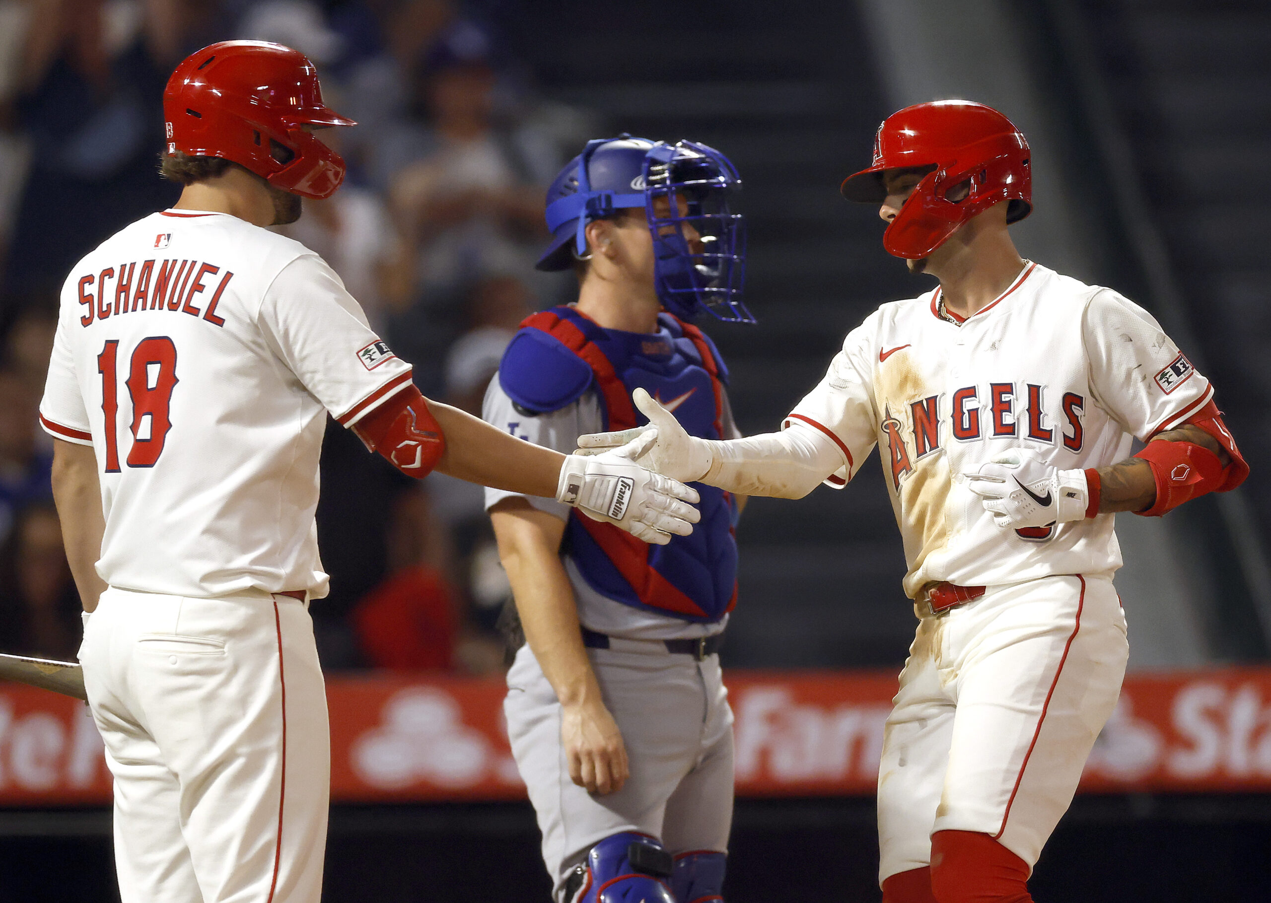 The Angels’ Zach Neto, right, celebrates with teammate Nolan Schanuel...