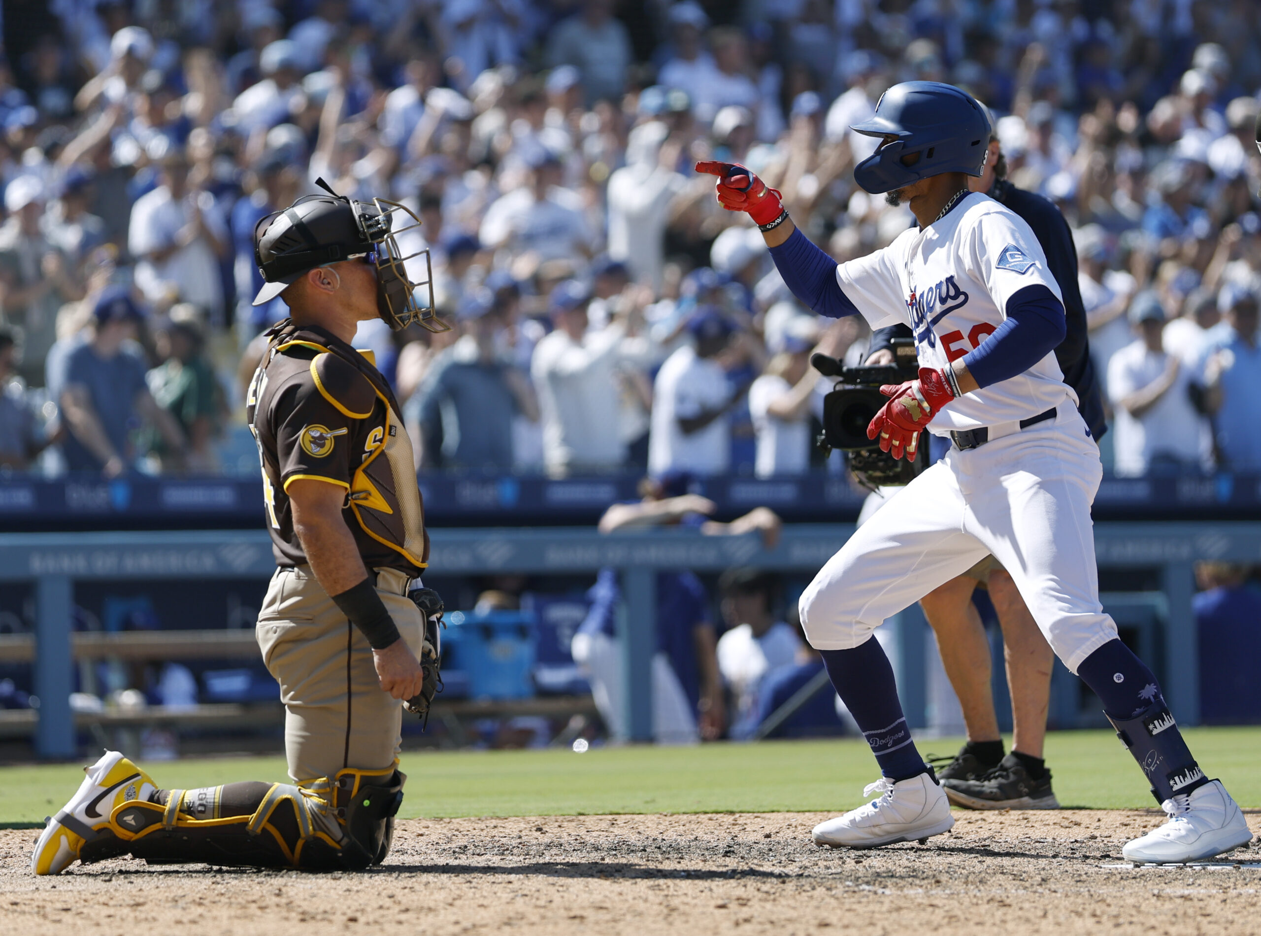 Mookie Betts of the Dodgers reacts to his solo home...