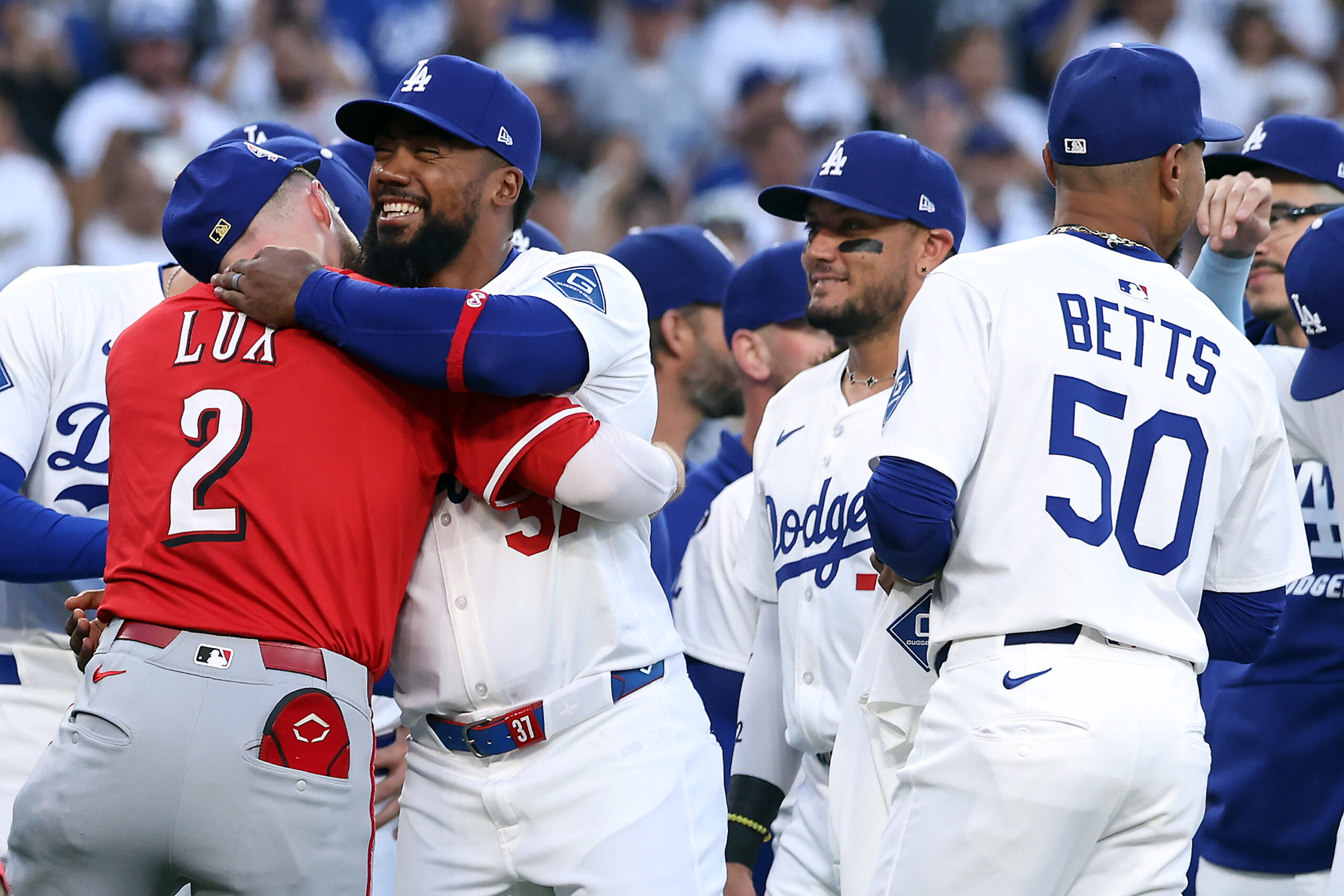 Cincinnati Reds infielder Gavin Lux, left, is greeted by former...