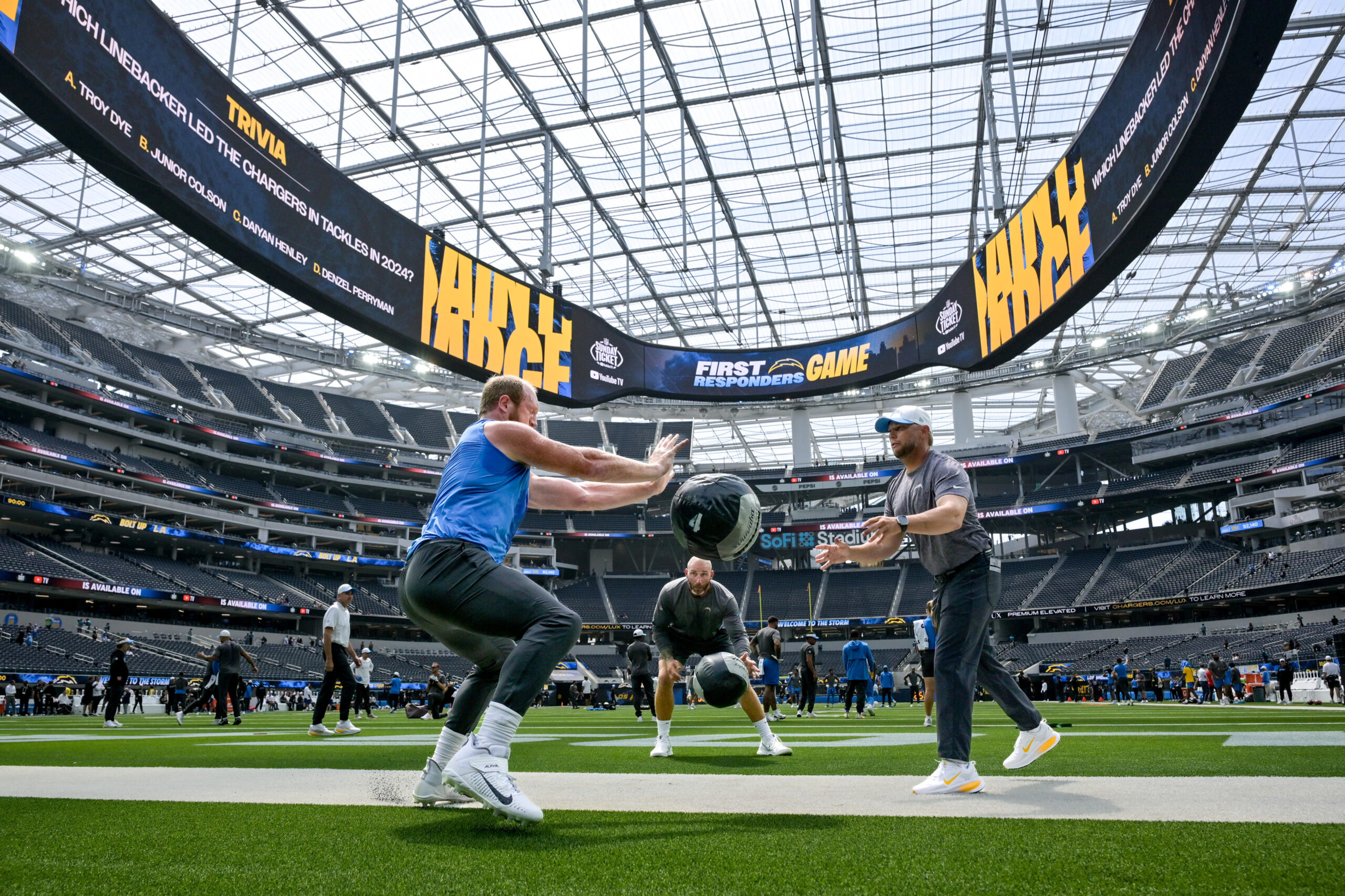 The Chargers warm up at SoFi Stadium for their pre-season...