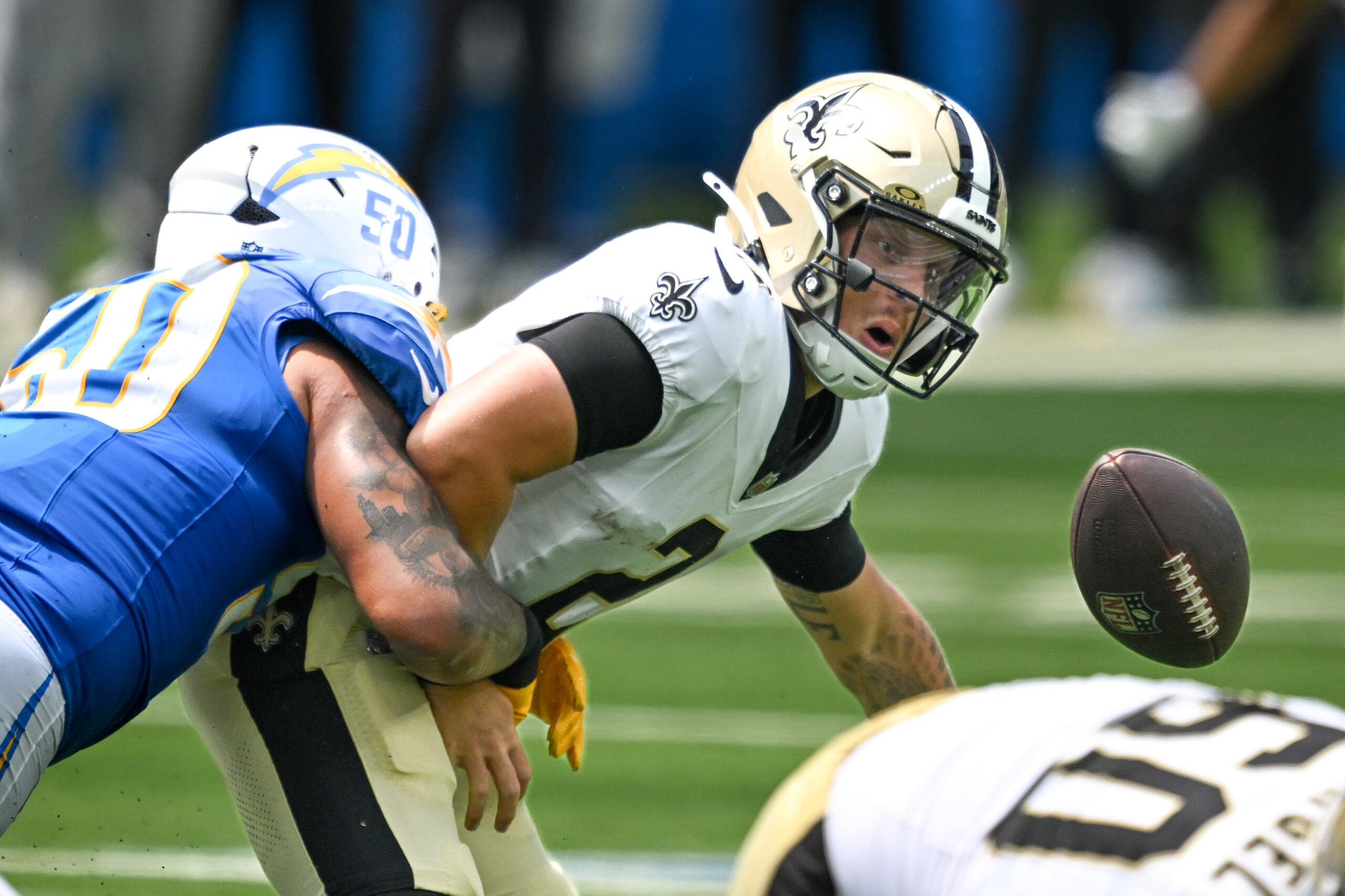 The Chargers Caleb Murphy,#50, forces Saints QB Spencer Rattler, #2,...