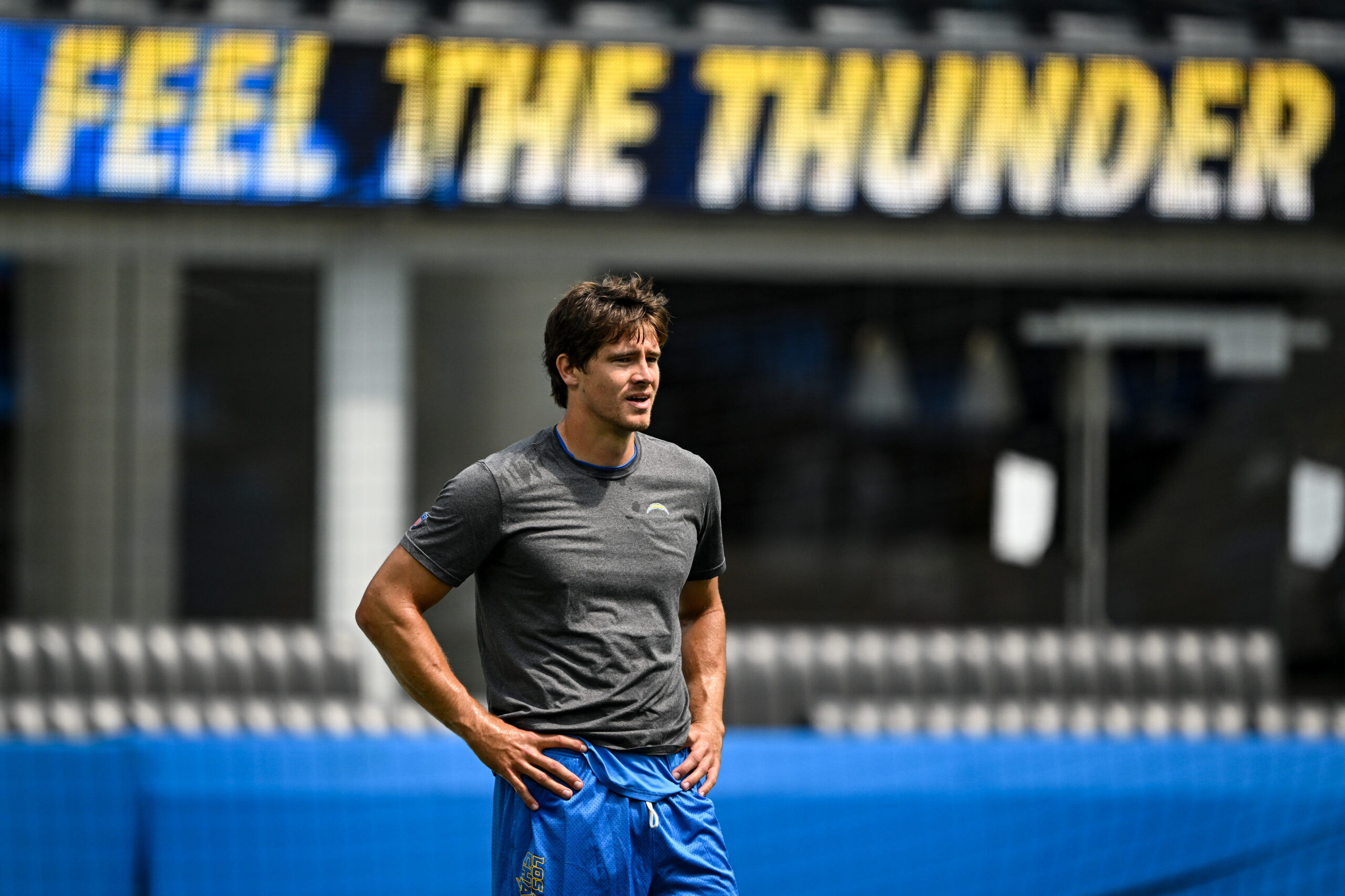 The Chargers QB Justin Herbert warms before the start of...