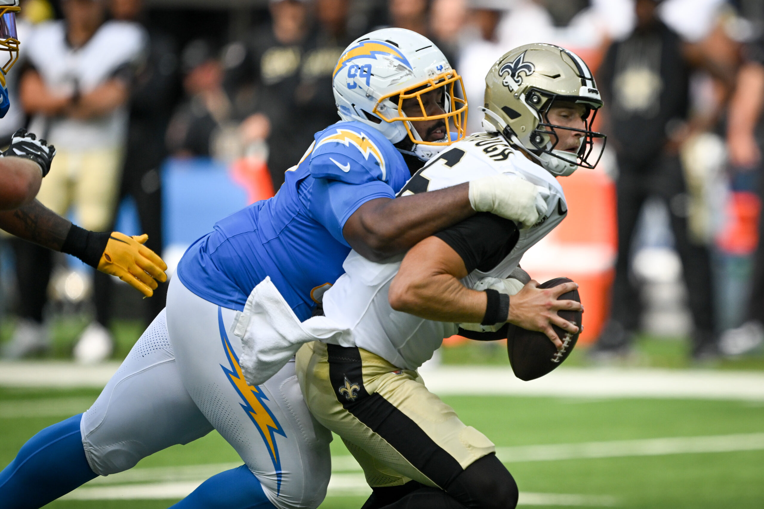 The Chargers TeRah Edwards, #94, sacks Saints QB Tyler Shough,...