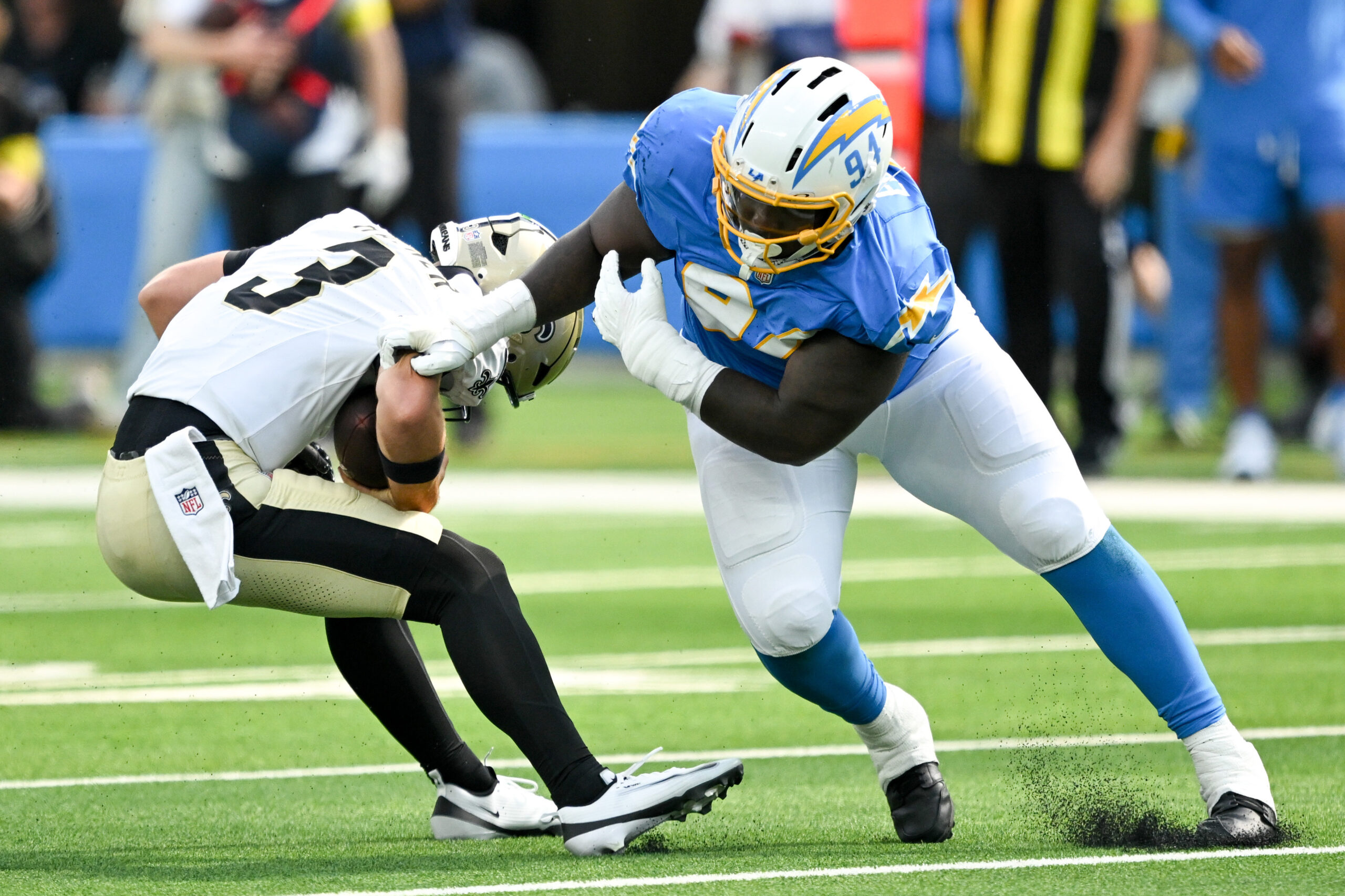 The Chargers TeRah Edwards, #94, gets a hand on Saints...