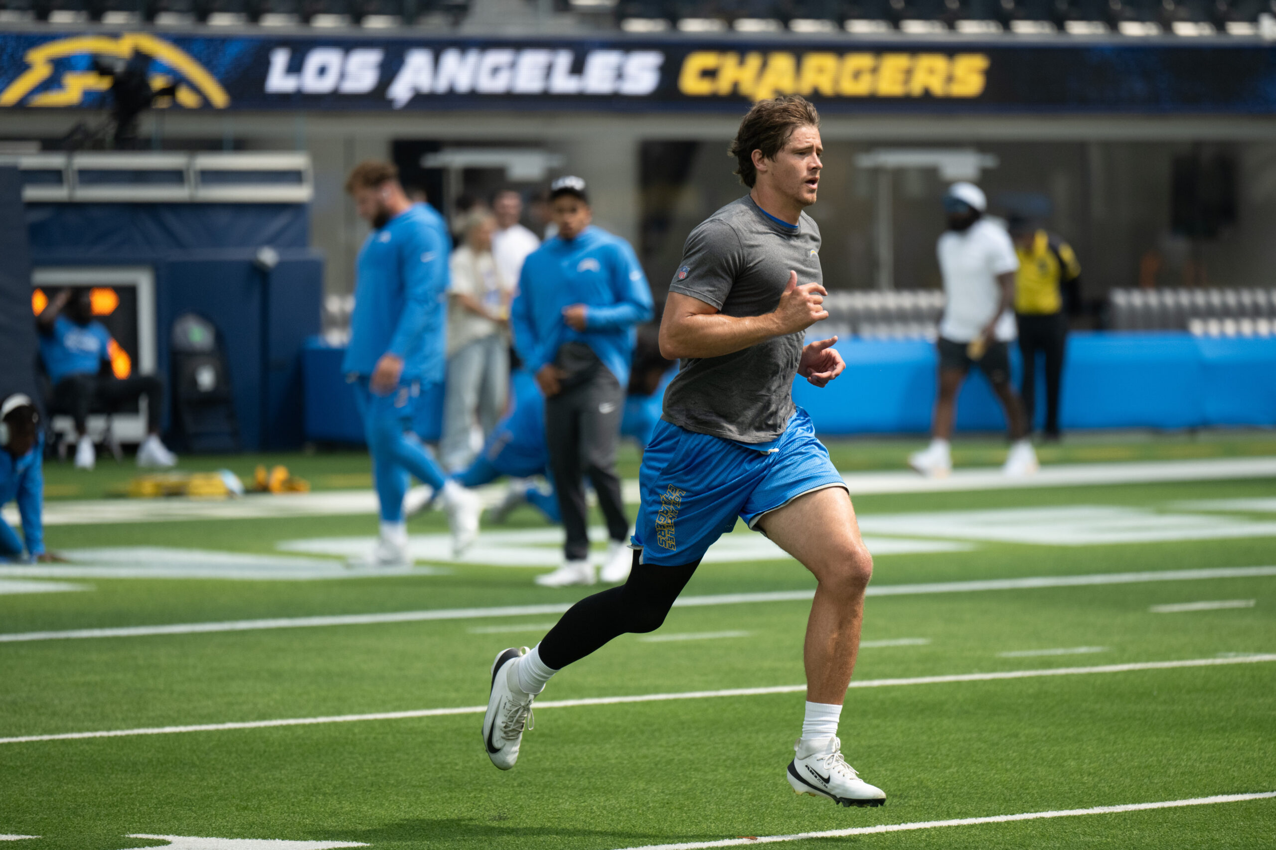 The Chargers QB Justin Herbert warms before the start of...