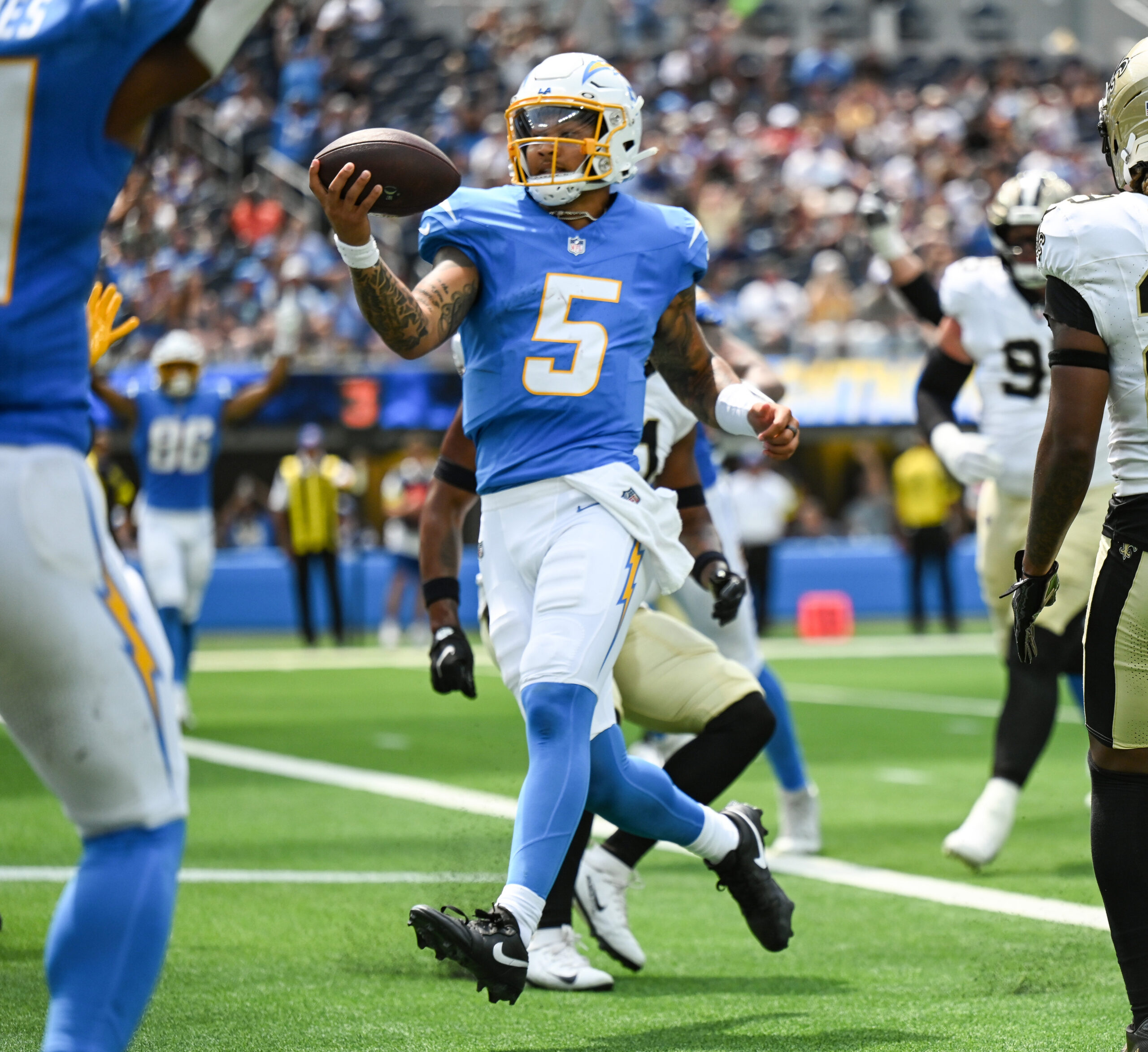 The Chargers quarterback Trey Lance, #5, runs in for a...