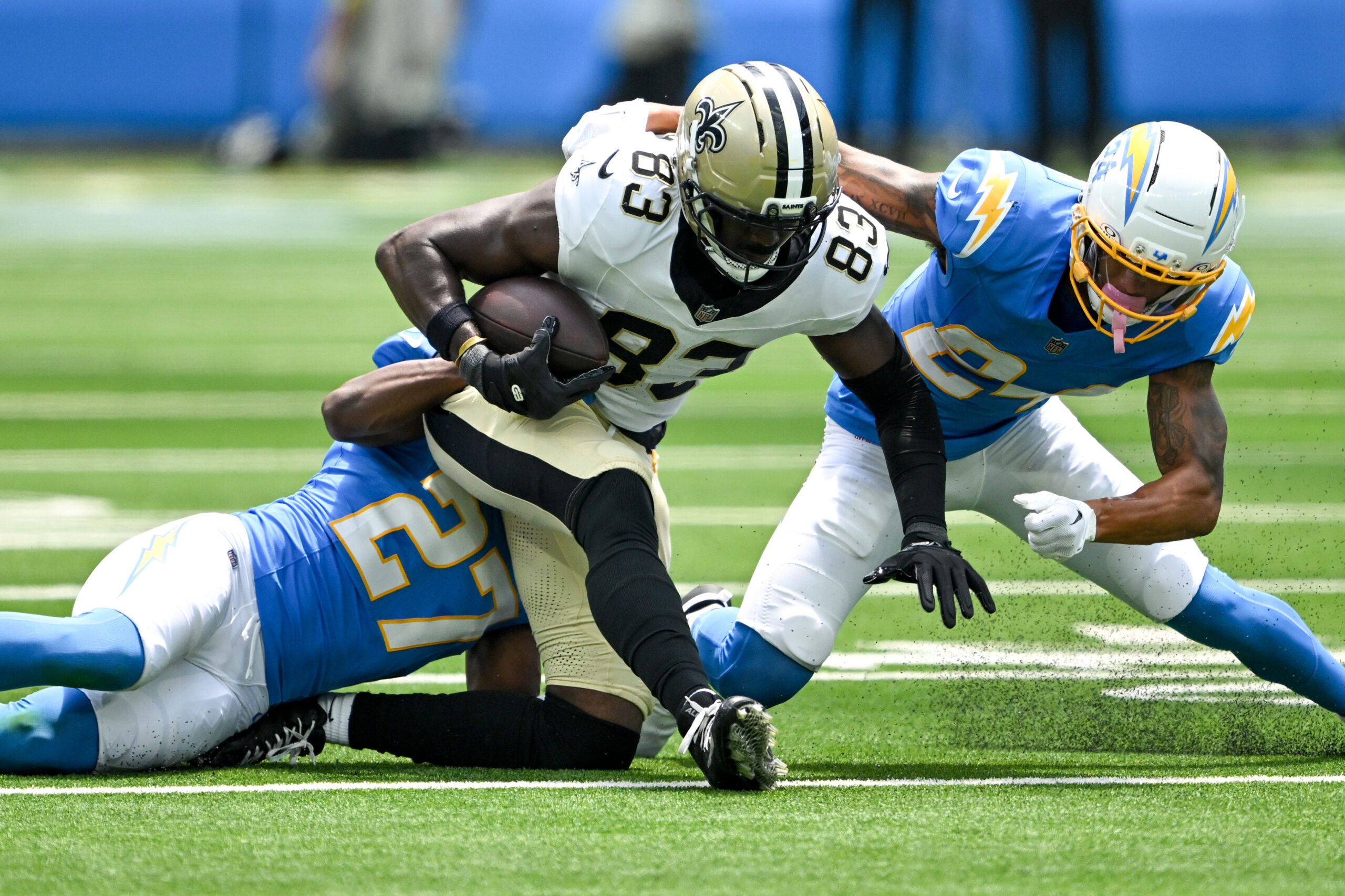 The Saints Juwan Johnson, #83, drives for yardages as Chargers...