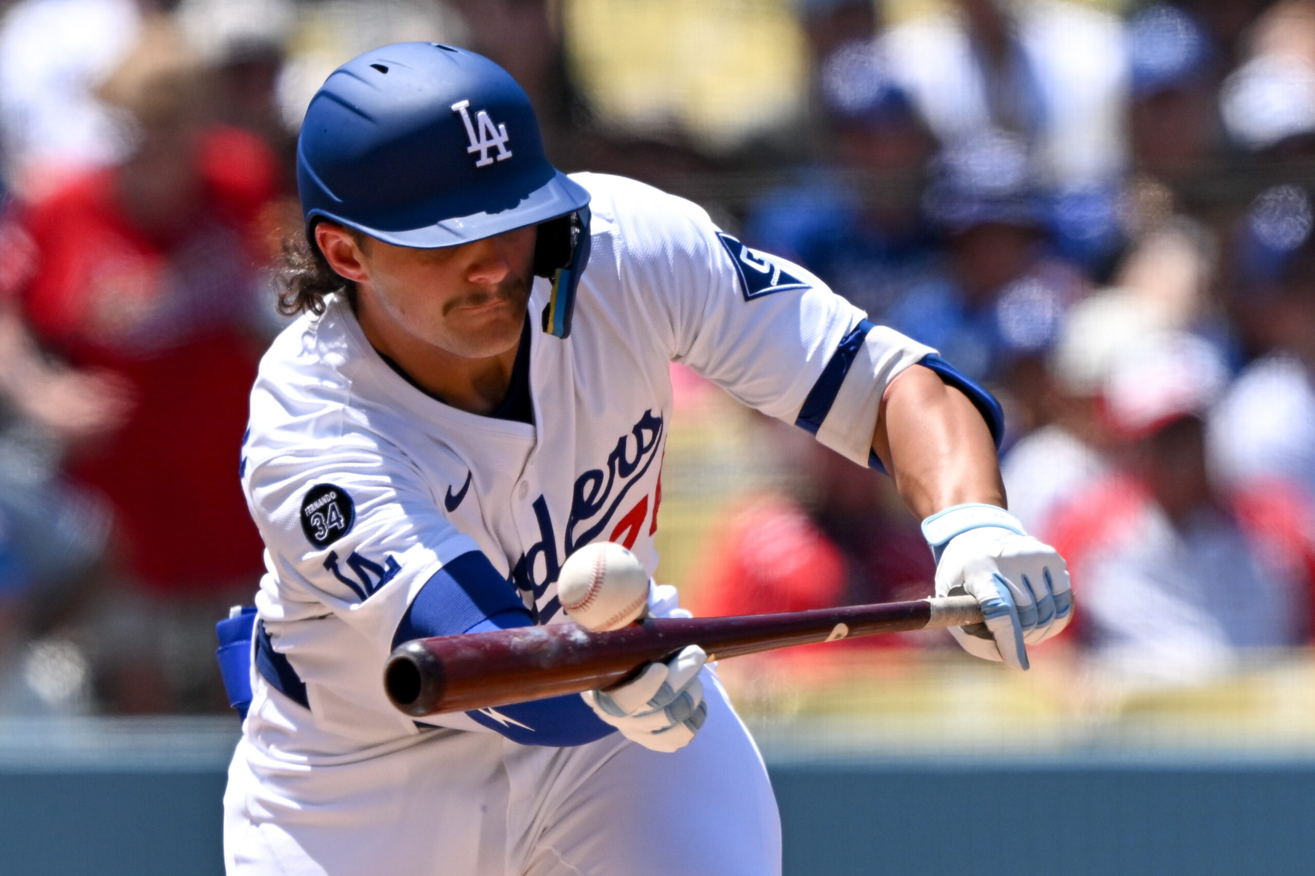 Dodgers Alex Freeland, #76, bunts during 3rd inning action on...