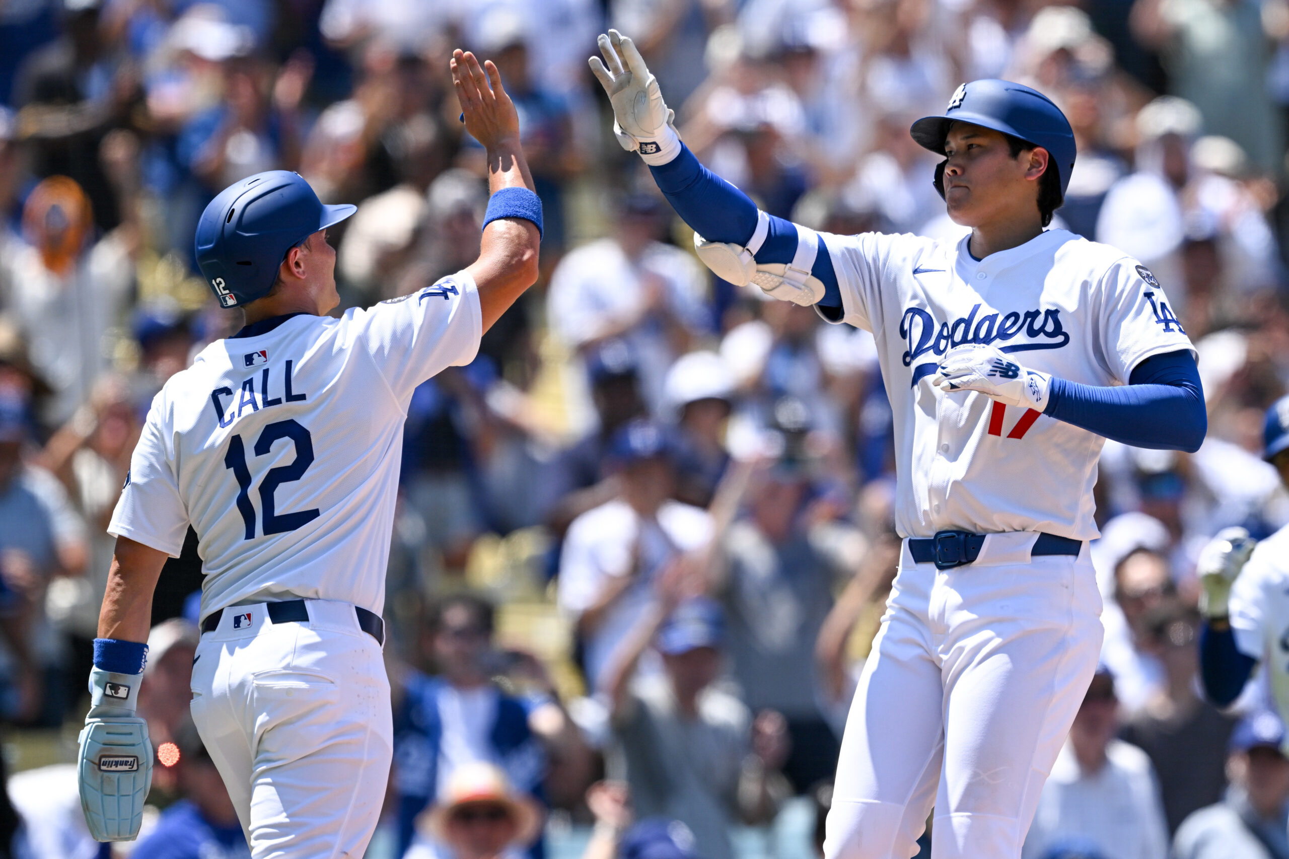 Dodgers Shohei Ohtani, #17, is greeted by Alex Call, #12,...