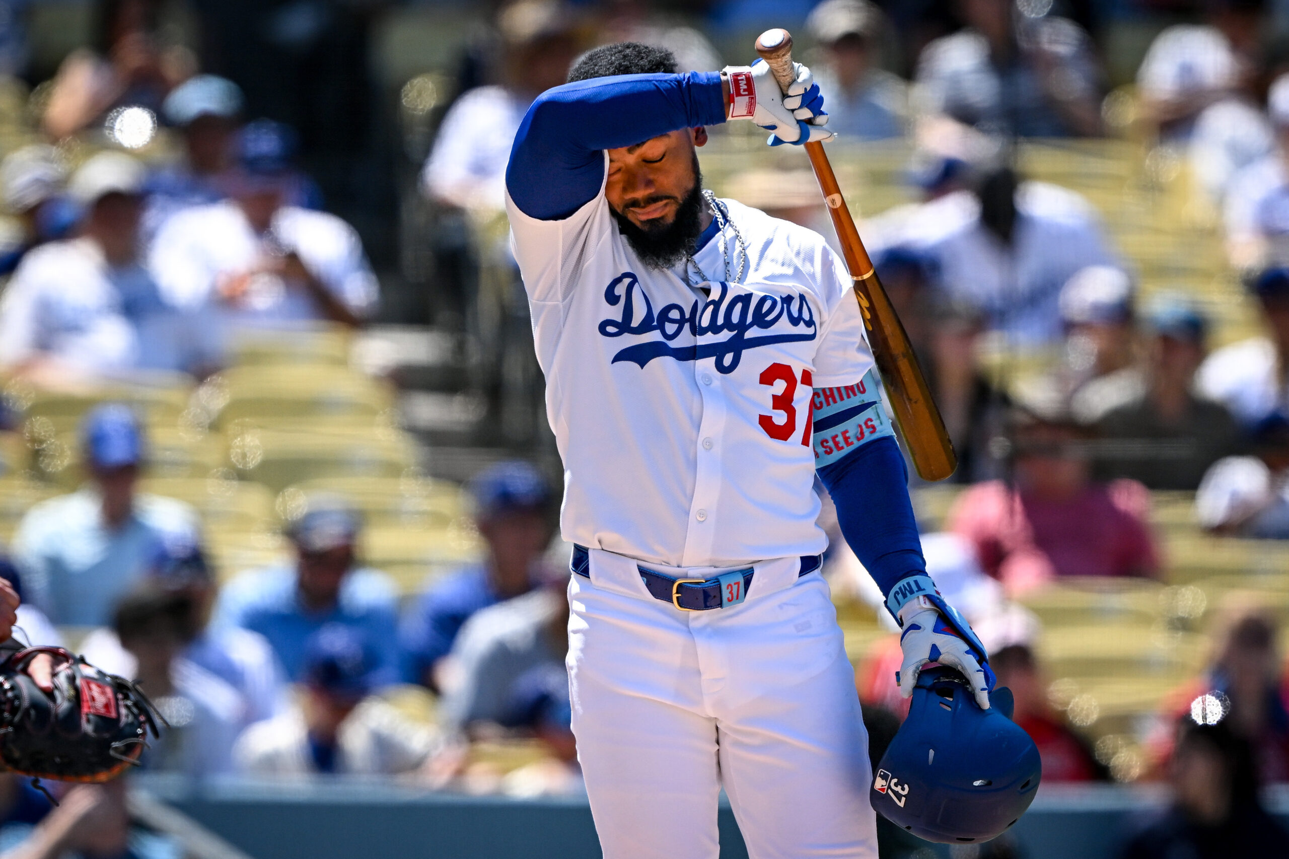 Dodgers Teoscar Hernandez, #37, wipes away sweat during his at-bat...