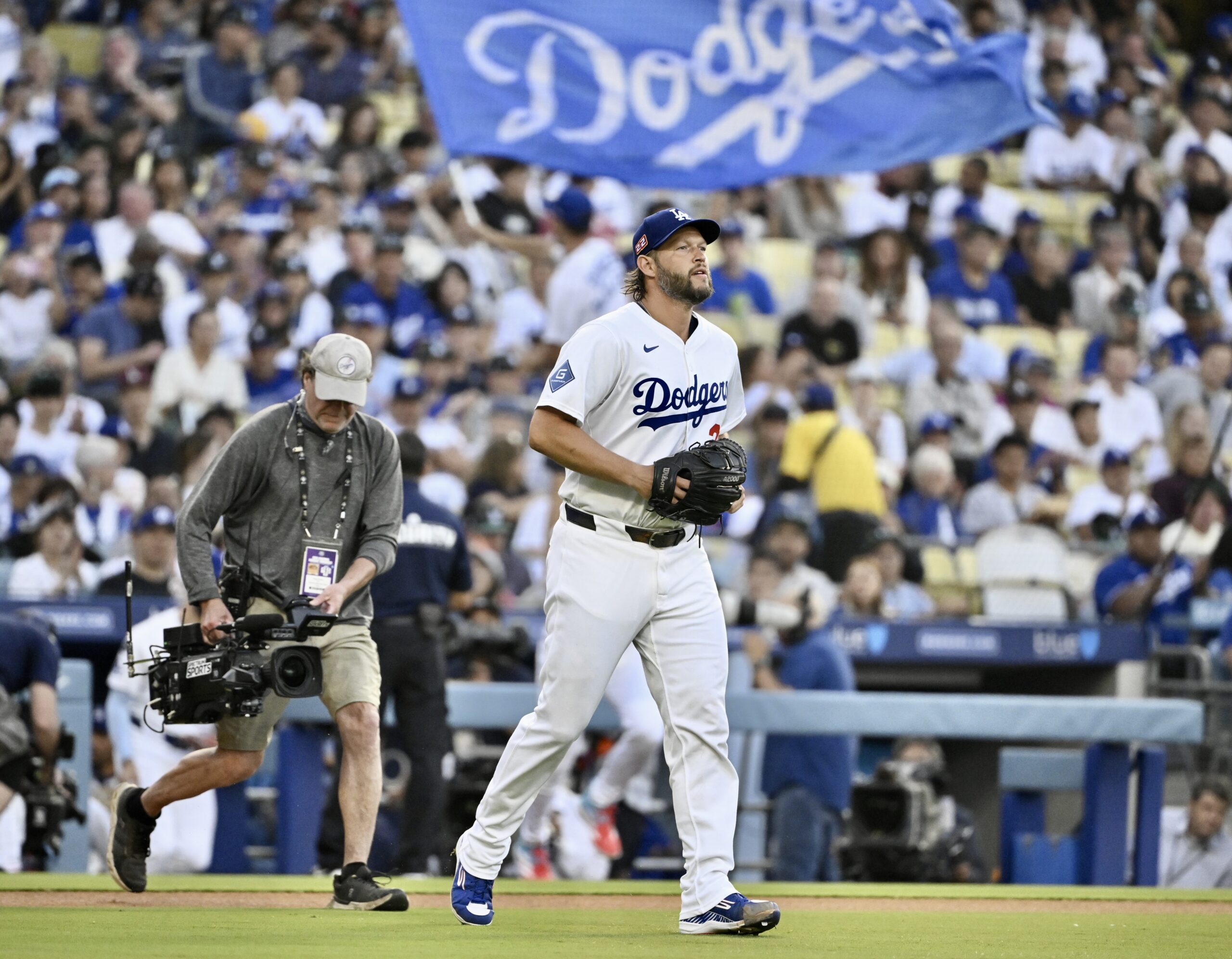 Dodgers starting pitcher Clayton Kershaw walks to the mound before...