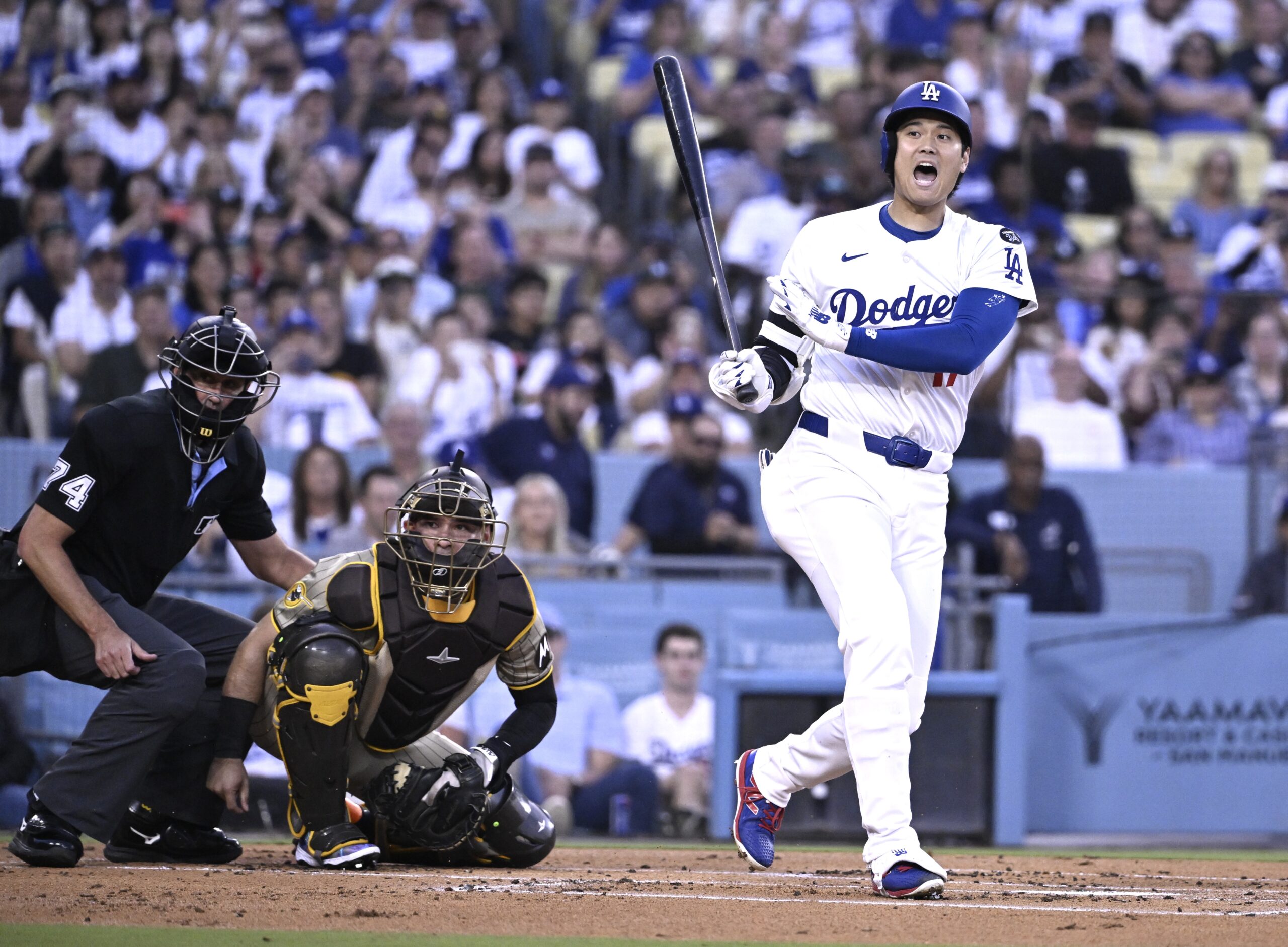Dodgers star Shohei Ohtani reacts after fouling a ball into...