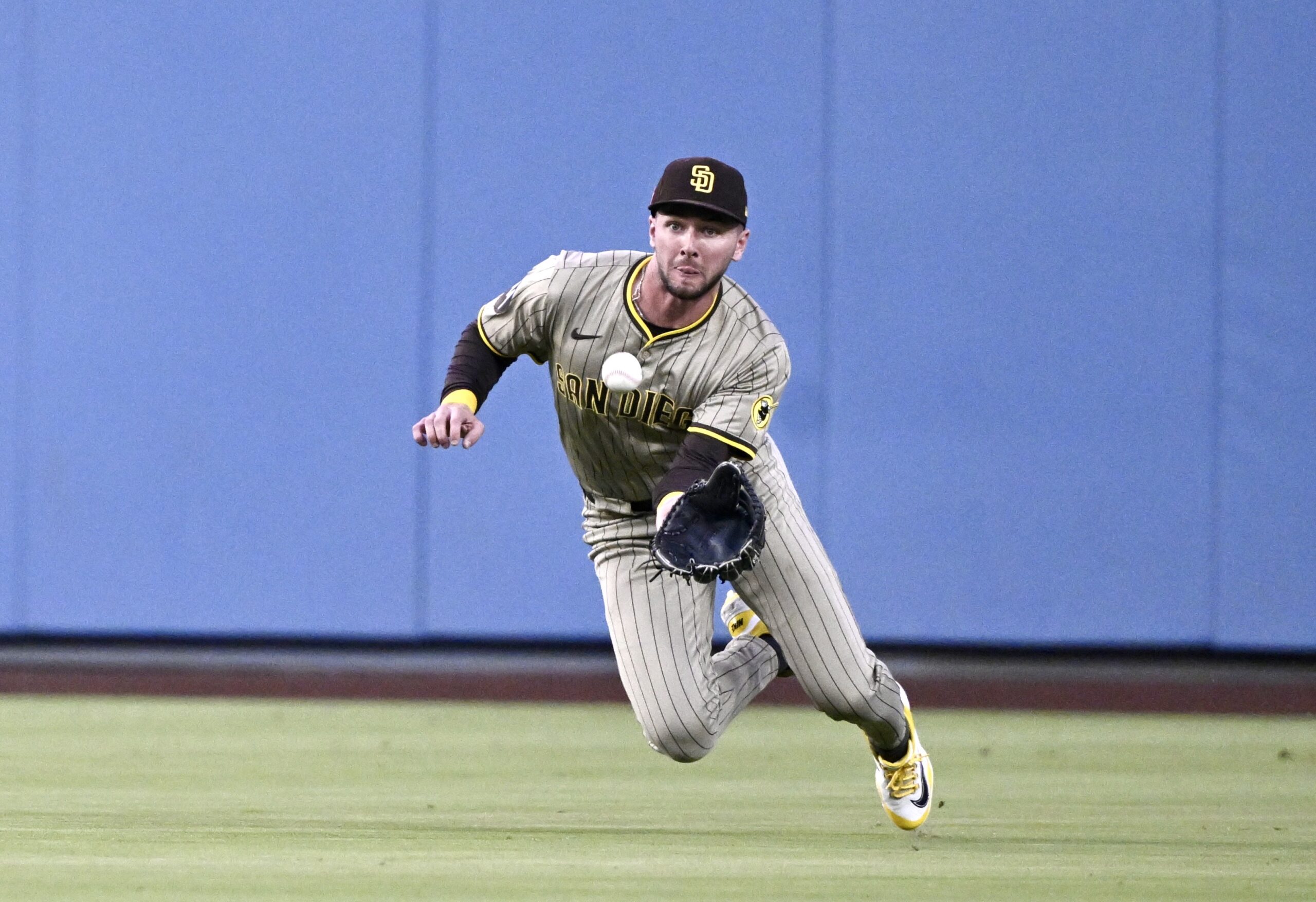 San Diego Padres center fielder Jackson Merrill makes a diving...