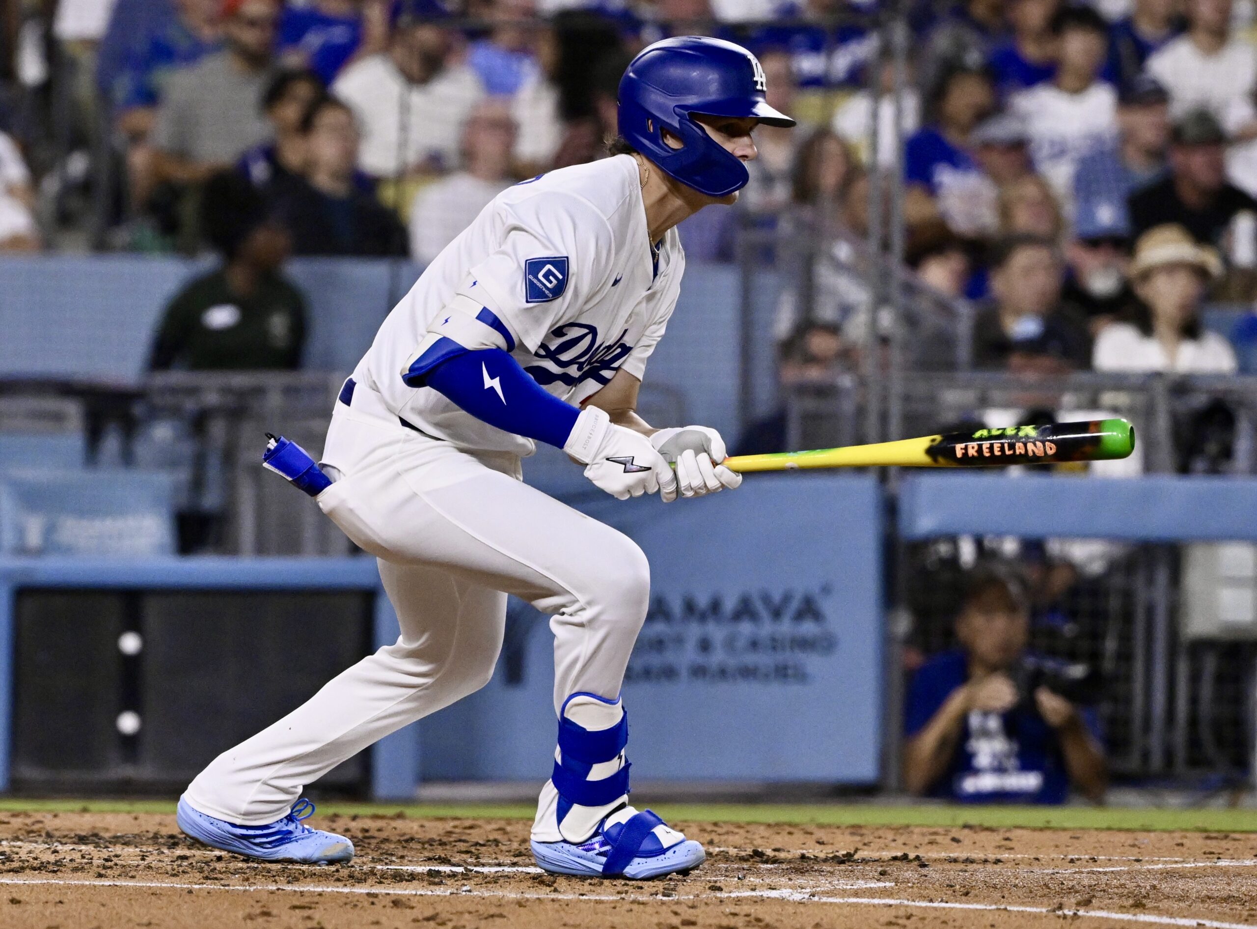 The Dodgers’ Alex Freeland hits a single during the third...