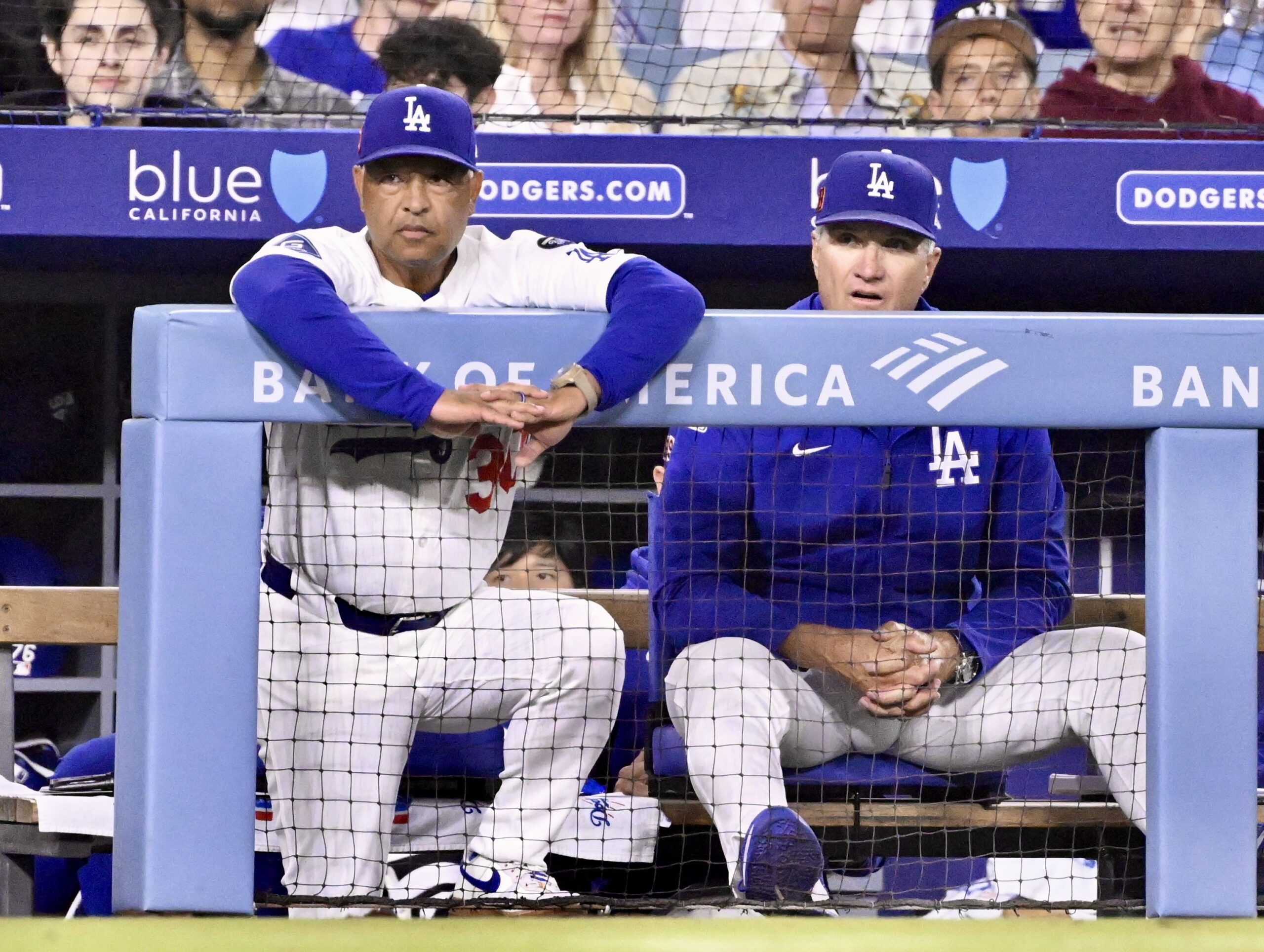 Dodgers manager Dave Roberts, left, and coach Bob Geren look...