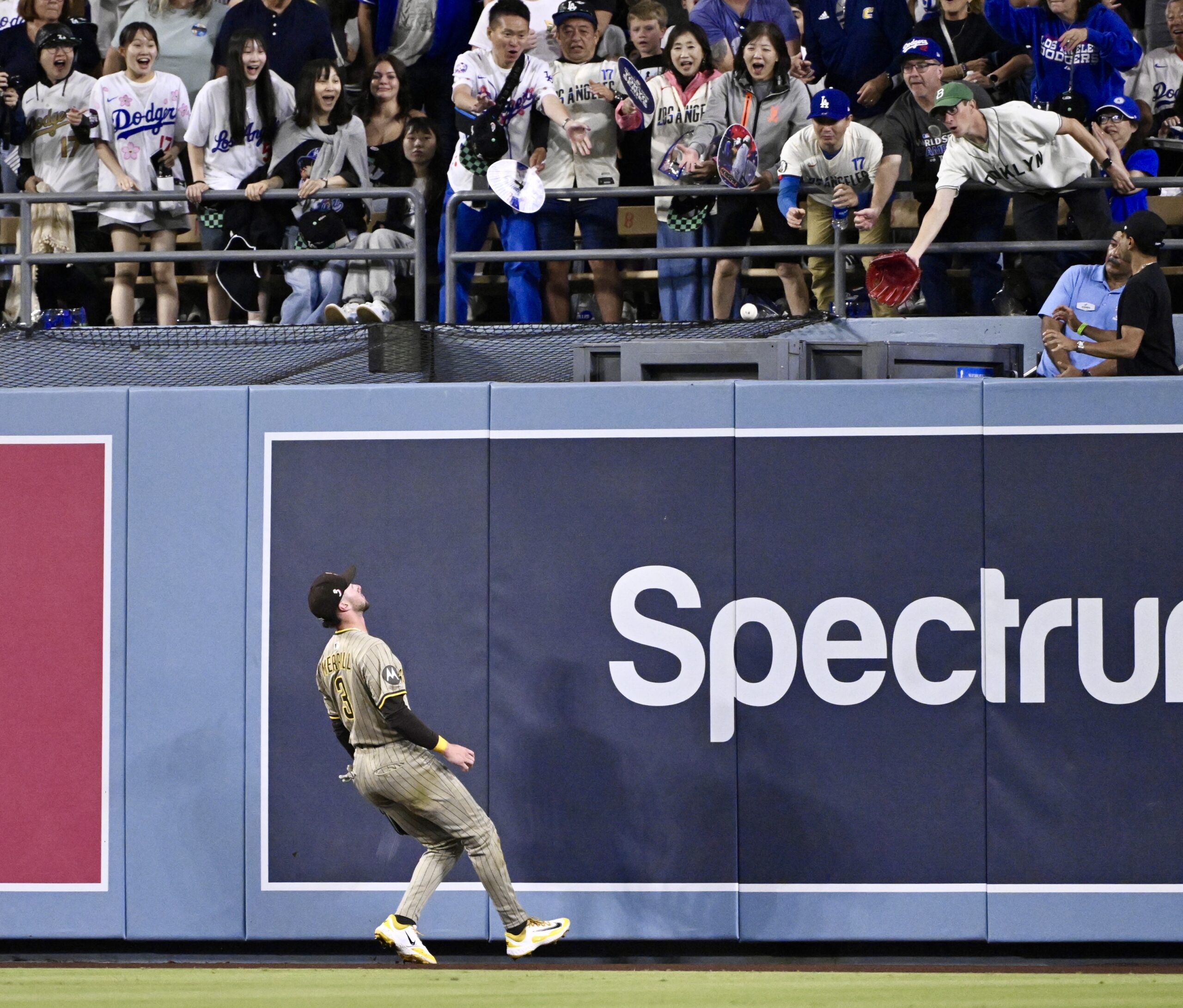 San Diego Padres center fielder Jackson Merrill watches as a...