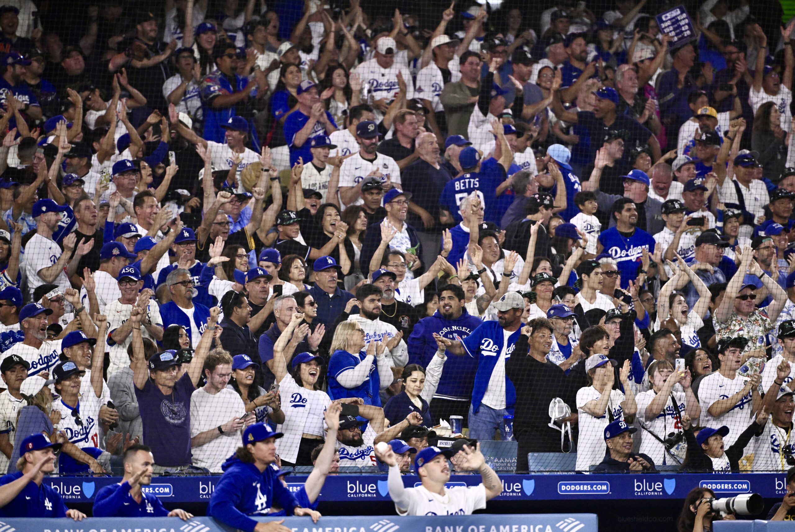 Dodger fans cheer after Teoscar Hernández (not pictured) hit a...