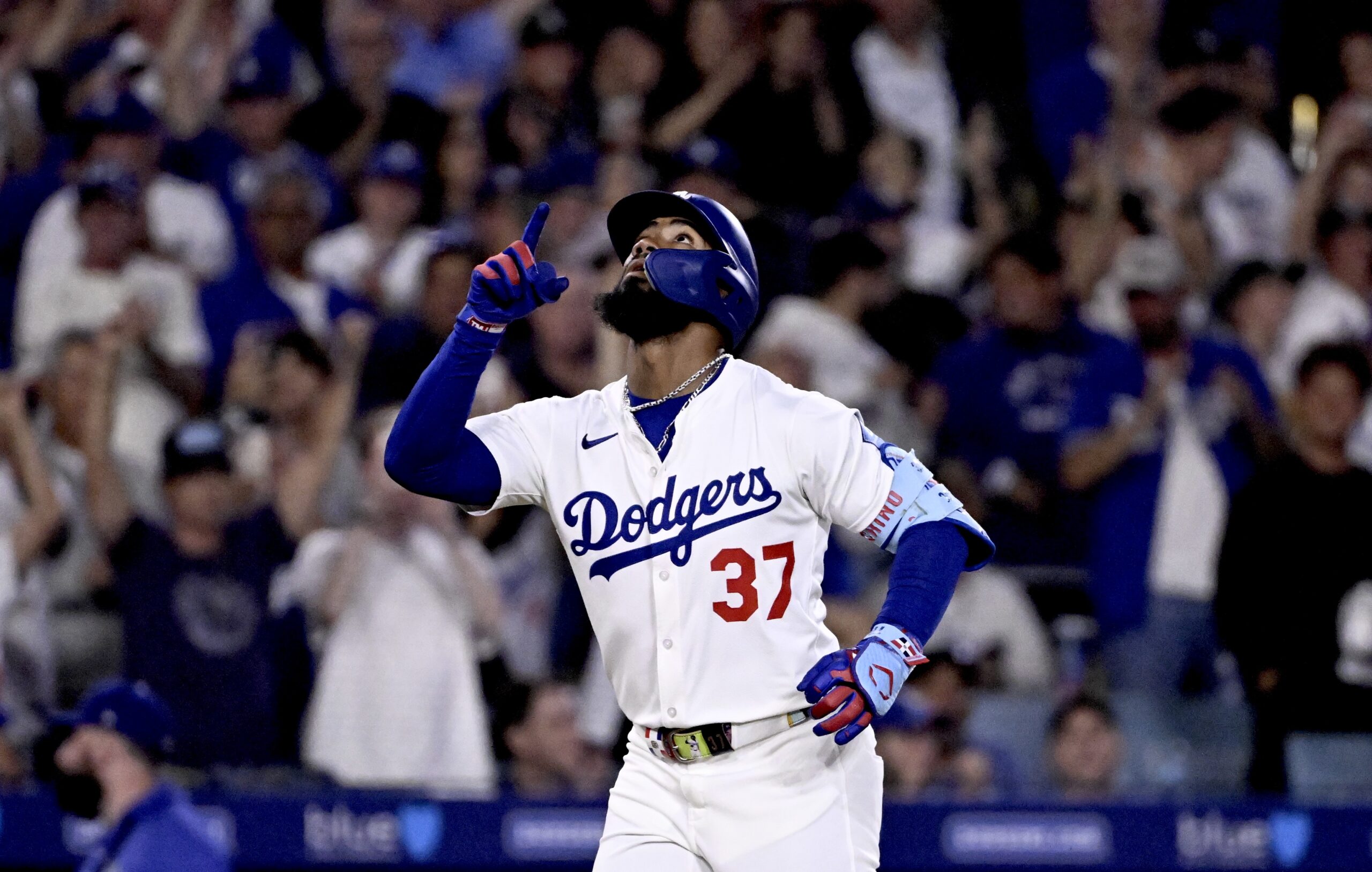 The Dodgers’ Teoscar Hernández points to the sky as he...