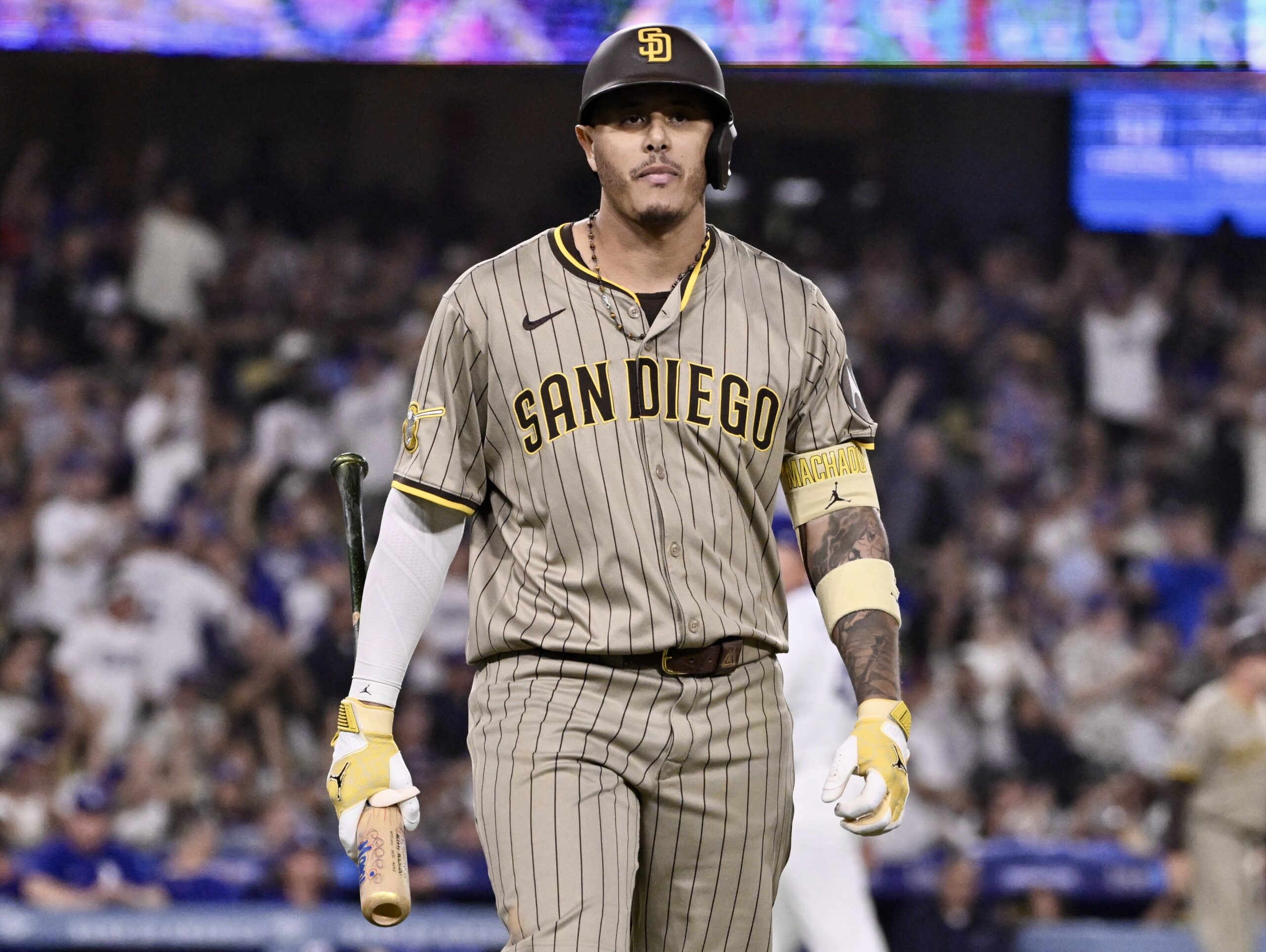 San Diego Padres star Manny Machado walks back to the...
