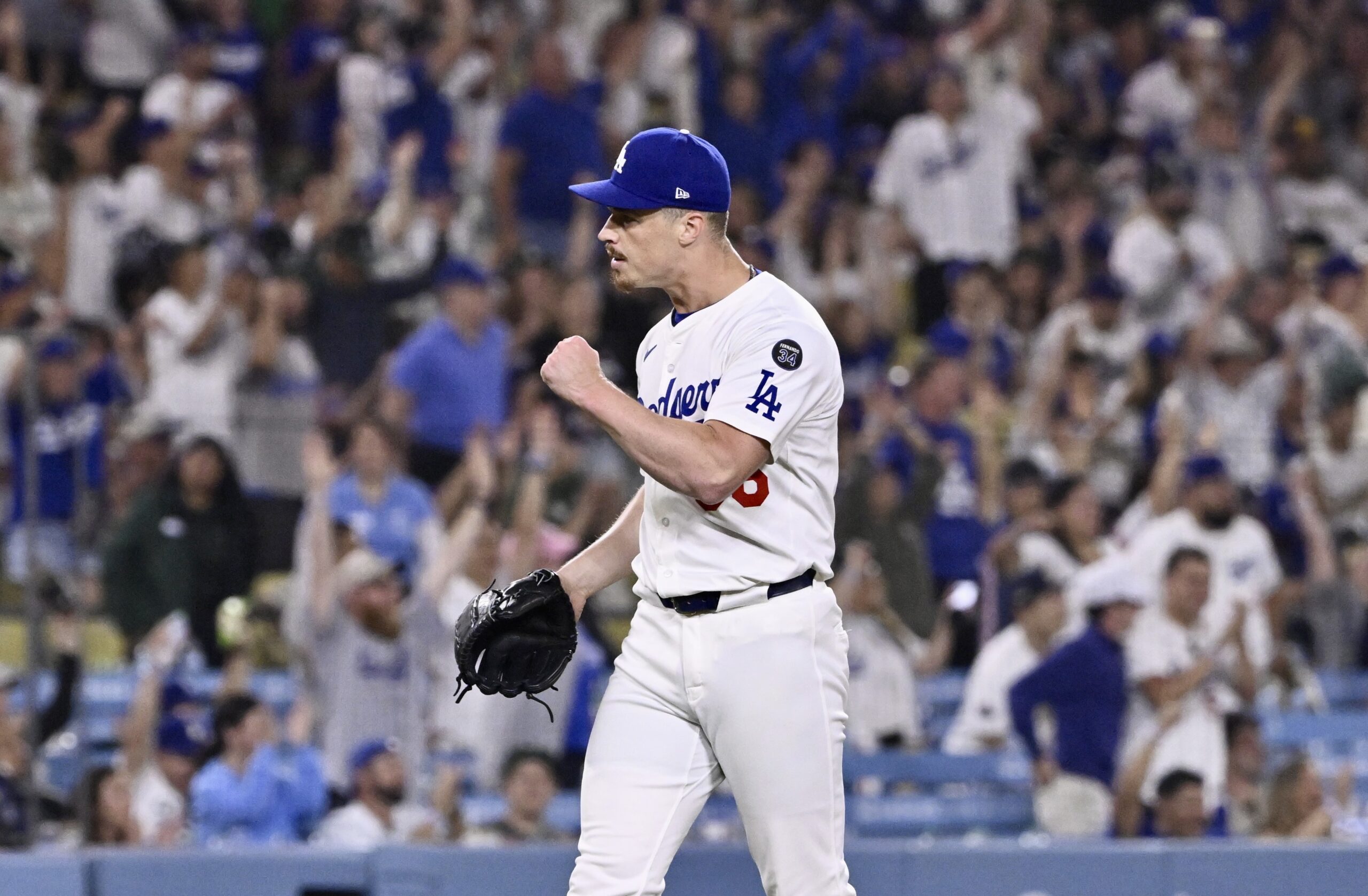 Dodgers relief pitcher Jack Dreyer pumps his first after getting...