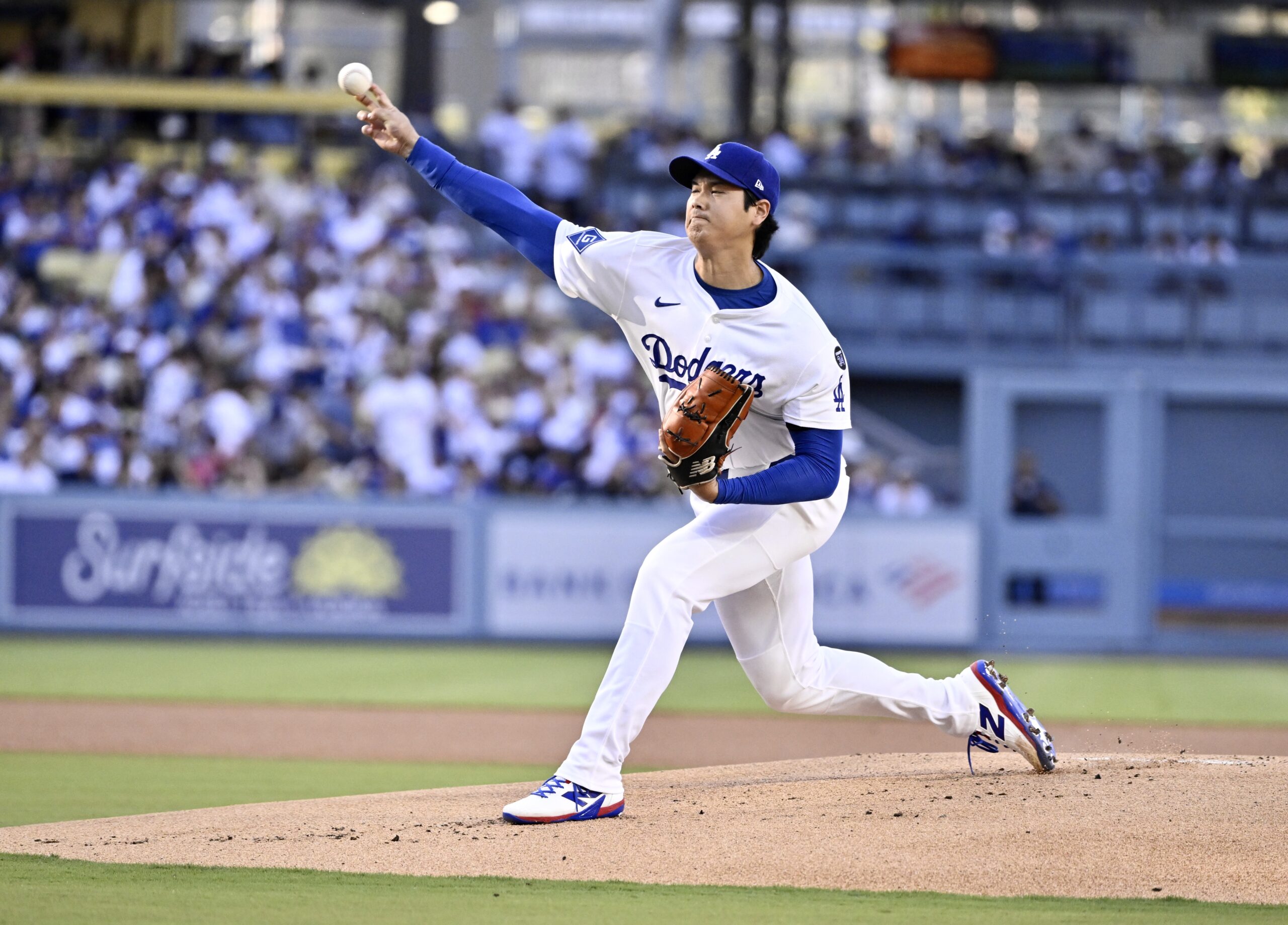 Dodgers starting pitcher Shohei Ohtani throws to the plate during...