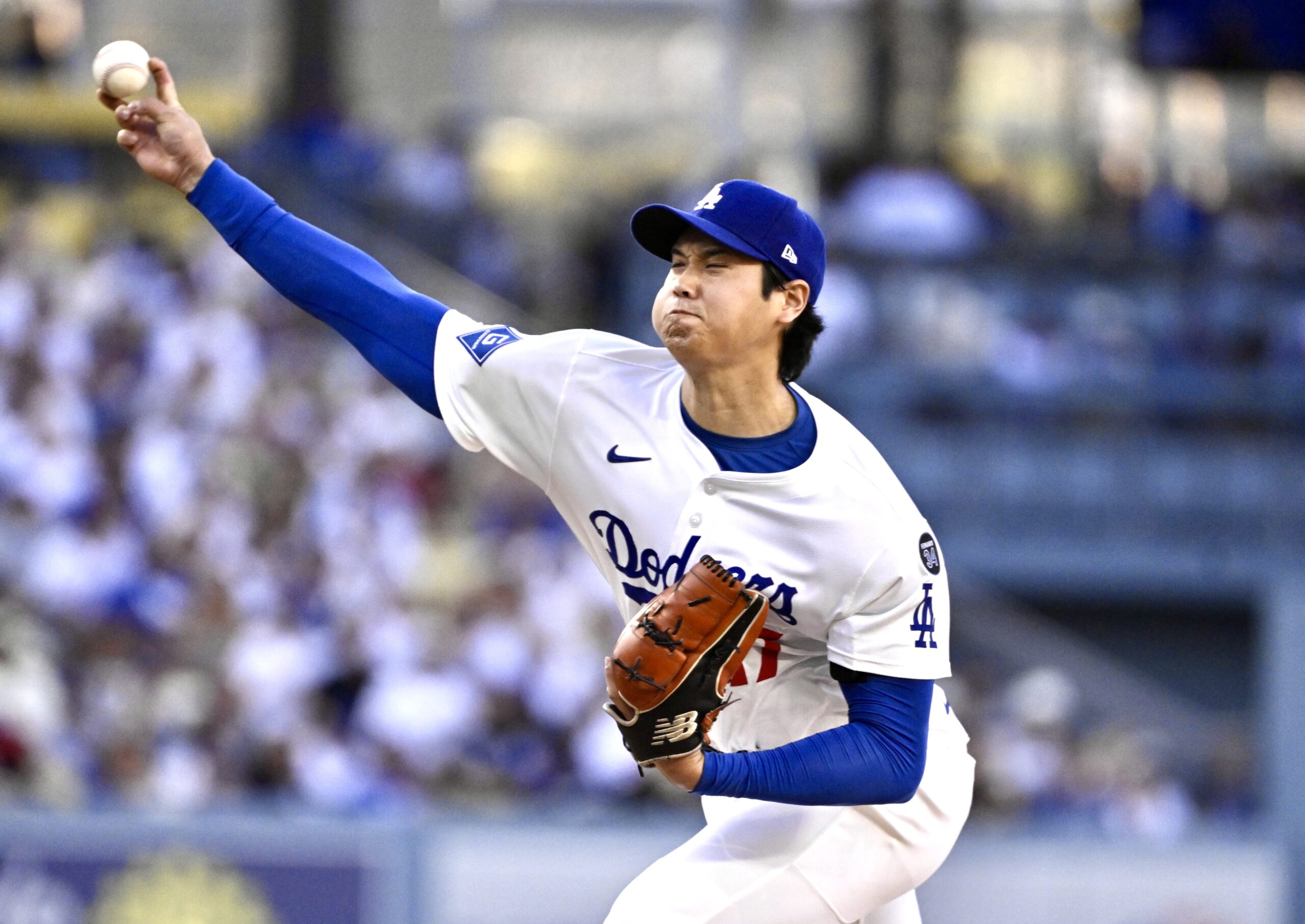 Dodgers starting pitcher Shohei Ohtani throws to the plate during...