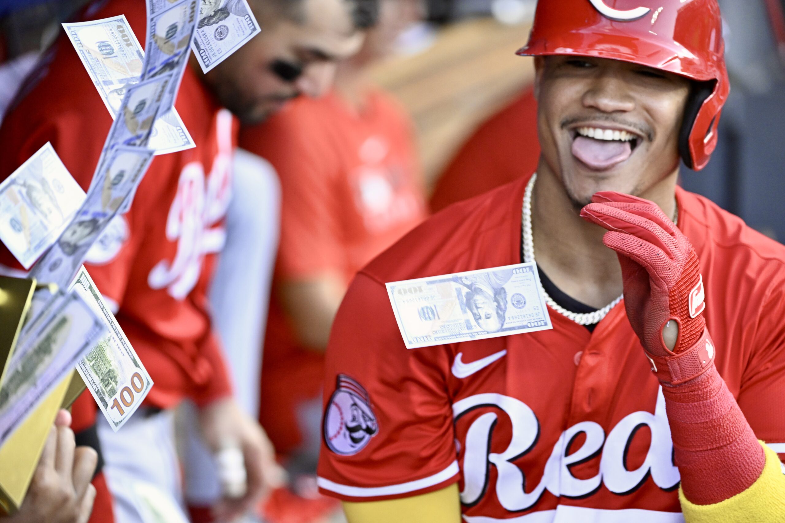 The Cincinnati Reds’ Noelvi Marte is showered with fake money...