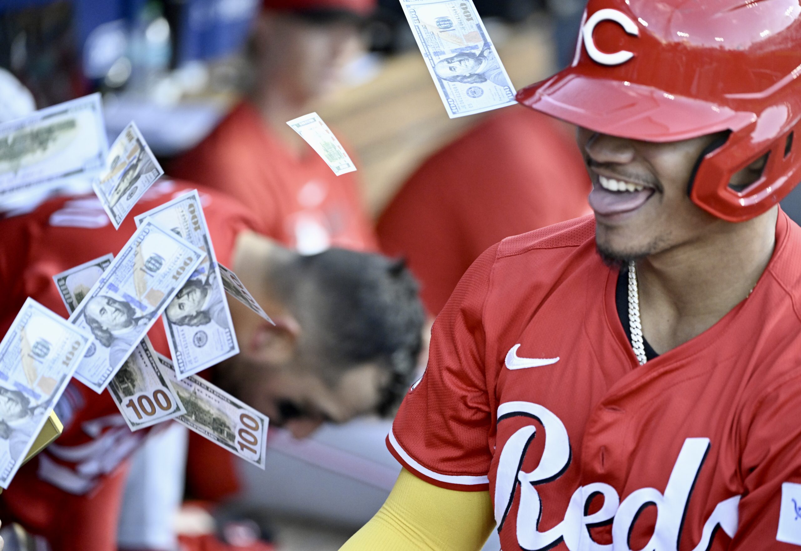 The Cincinnati Reds’ Noelvi Marte is showered with fake money...