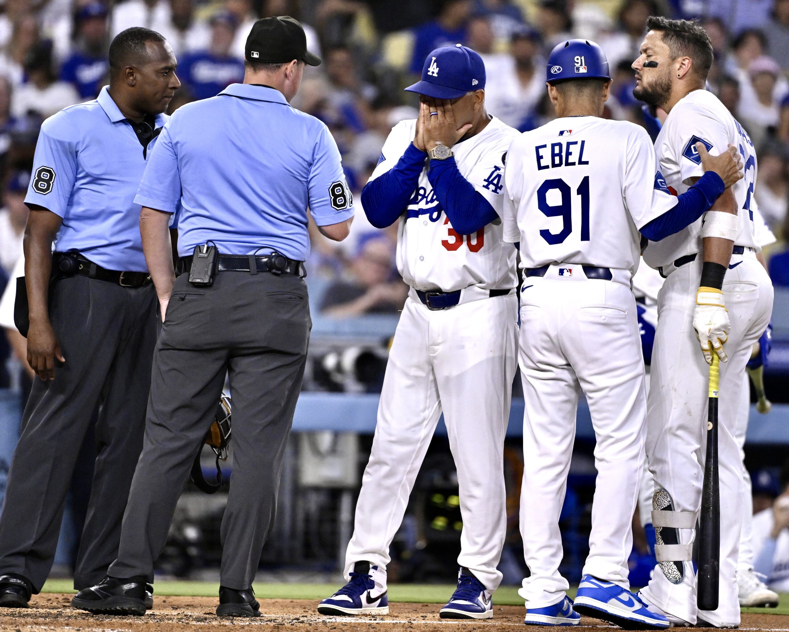 Dodgers manager Dave Roberts reacts toward the umpires after Miguel...