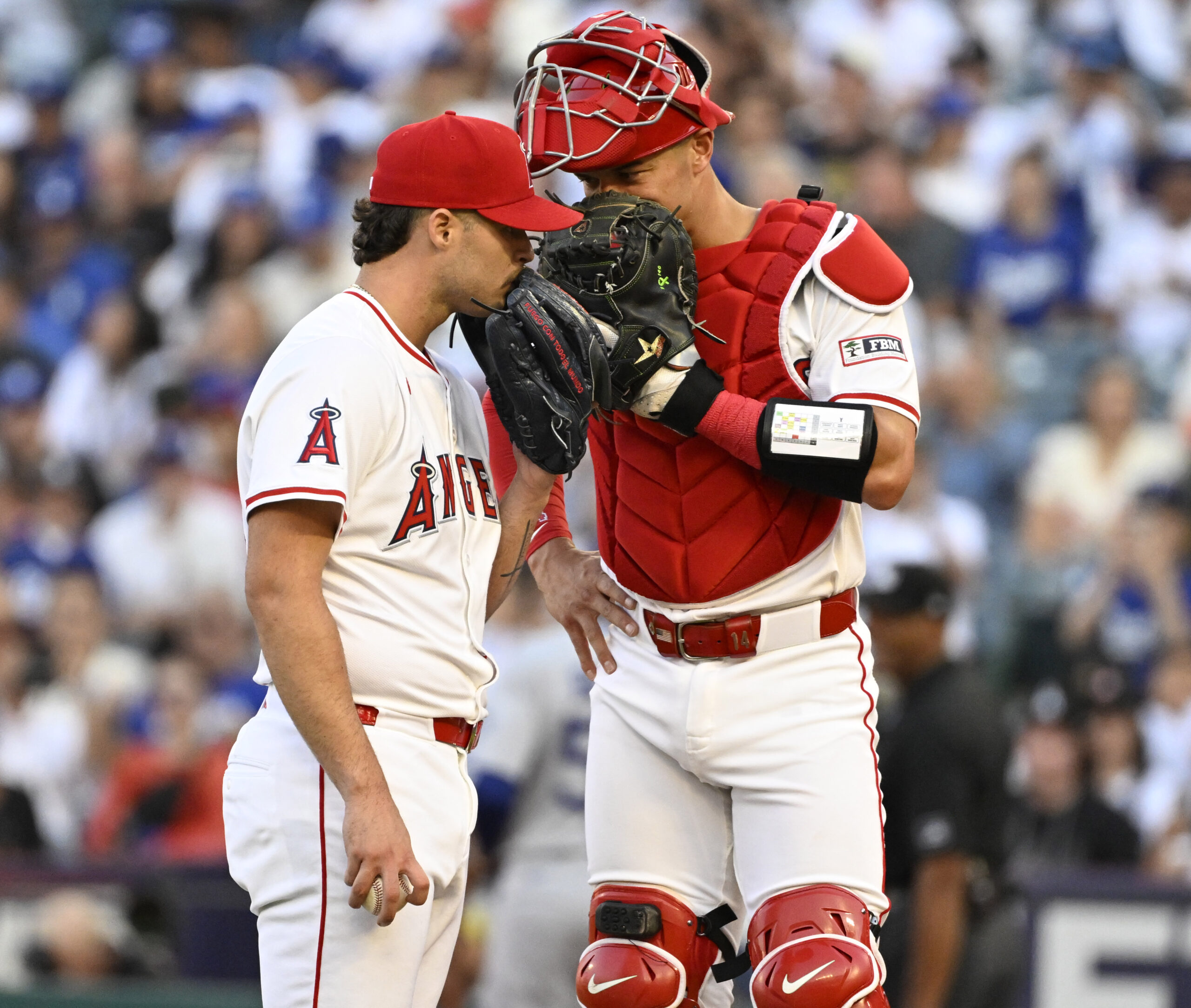 Angels starting pitcher Victor Mederos, left, talks with catcher Logan...