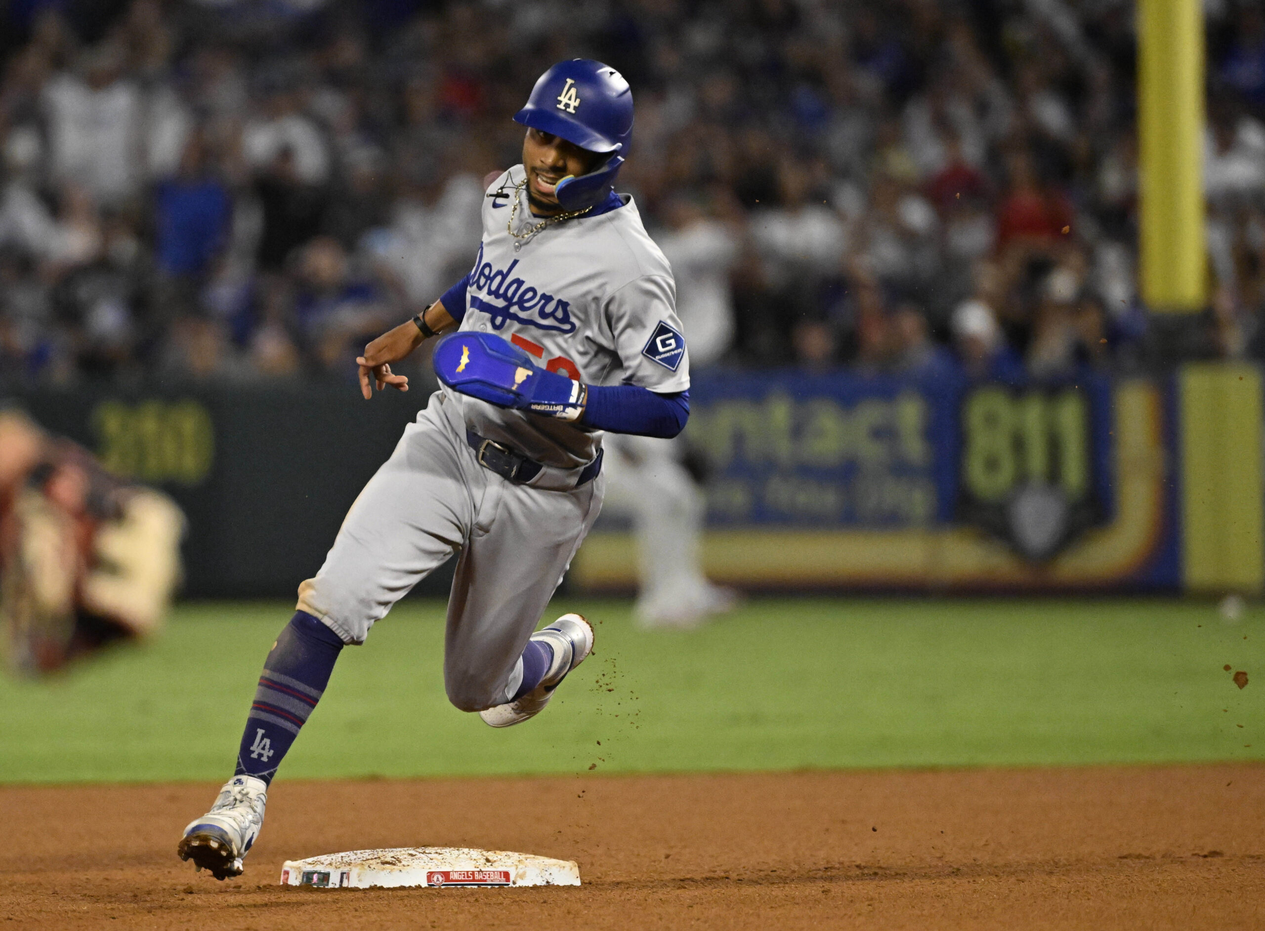 The Dodgers’ Mookie Betts advances to third base on a...