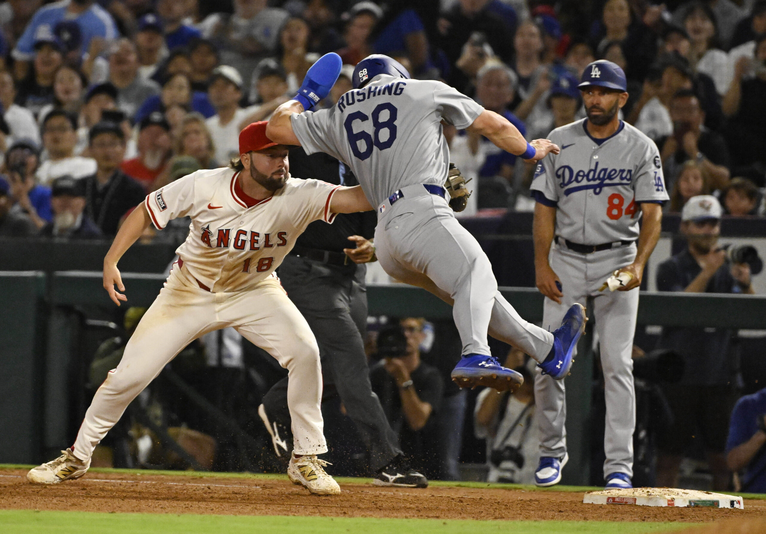 Angels first baseman Nolan Schanuel, left, tags the Dodgers’ Dalton...