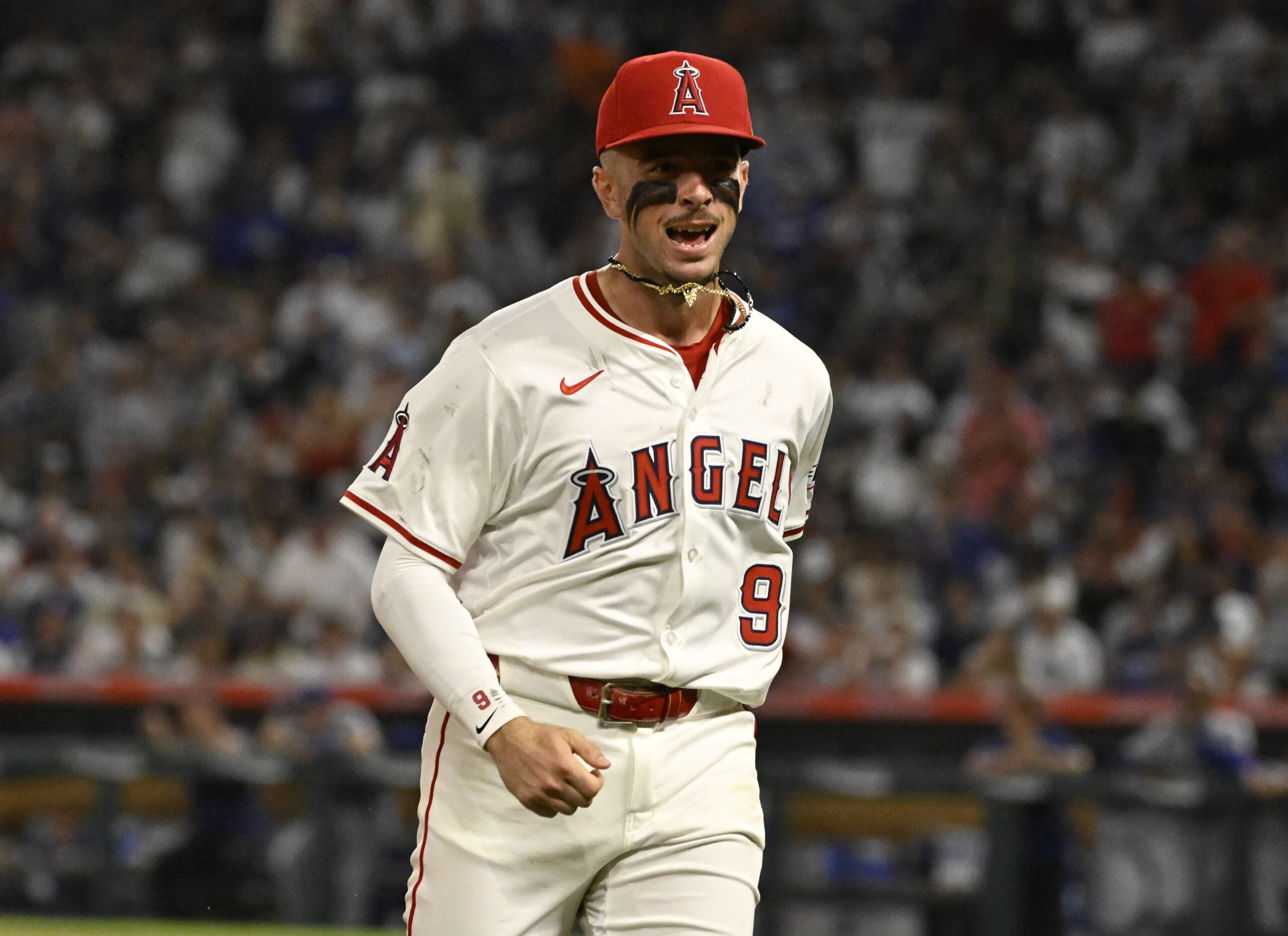 Angels shortstop Zach Neto celebrates as he runs off the...