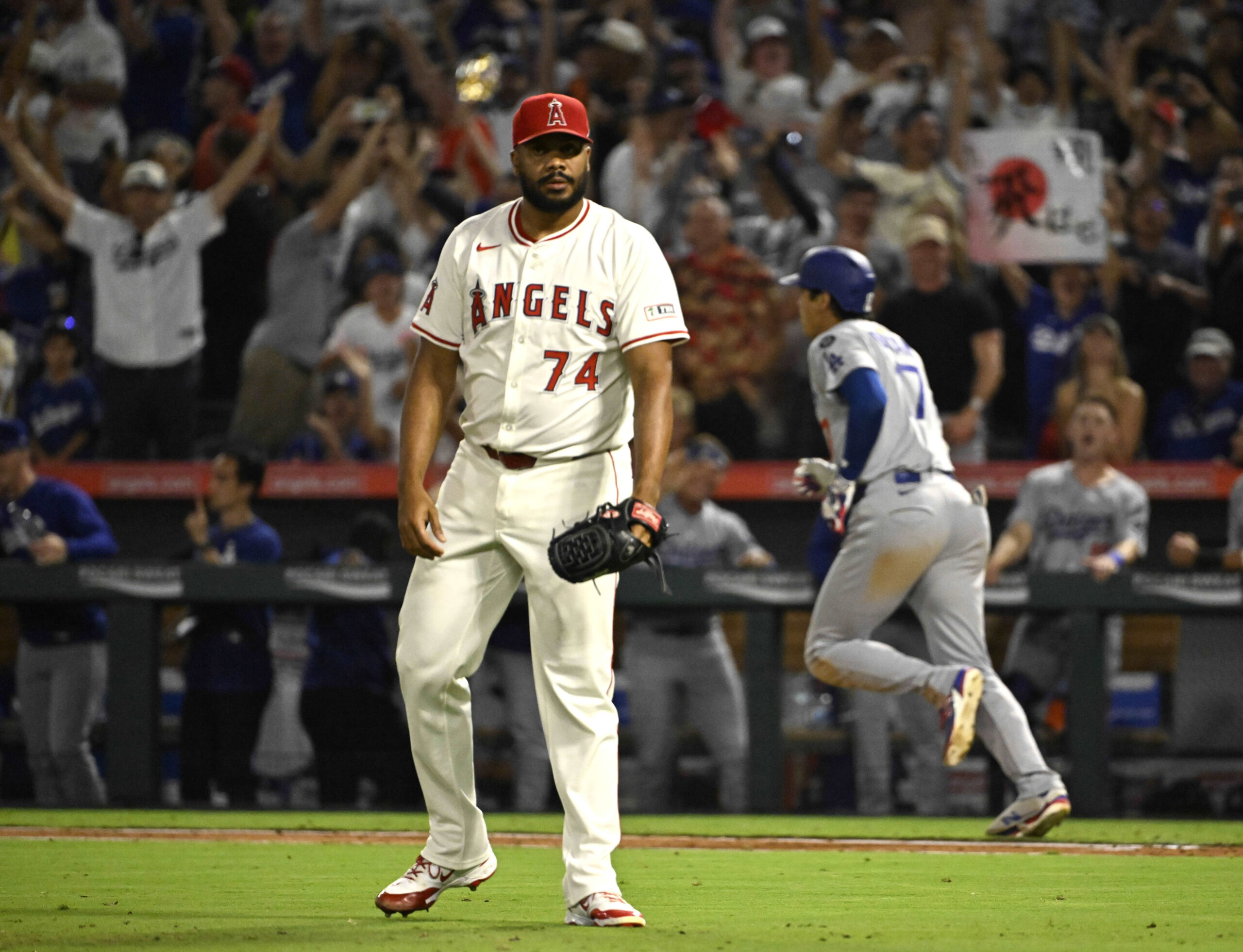Angels relief pitcher Kenley Jansen shows his frustration after giving...